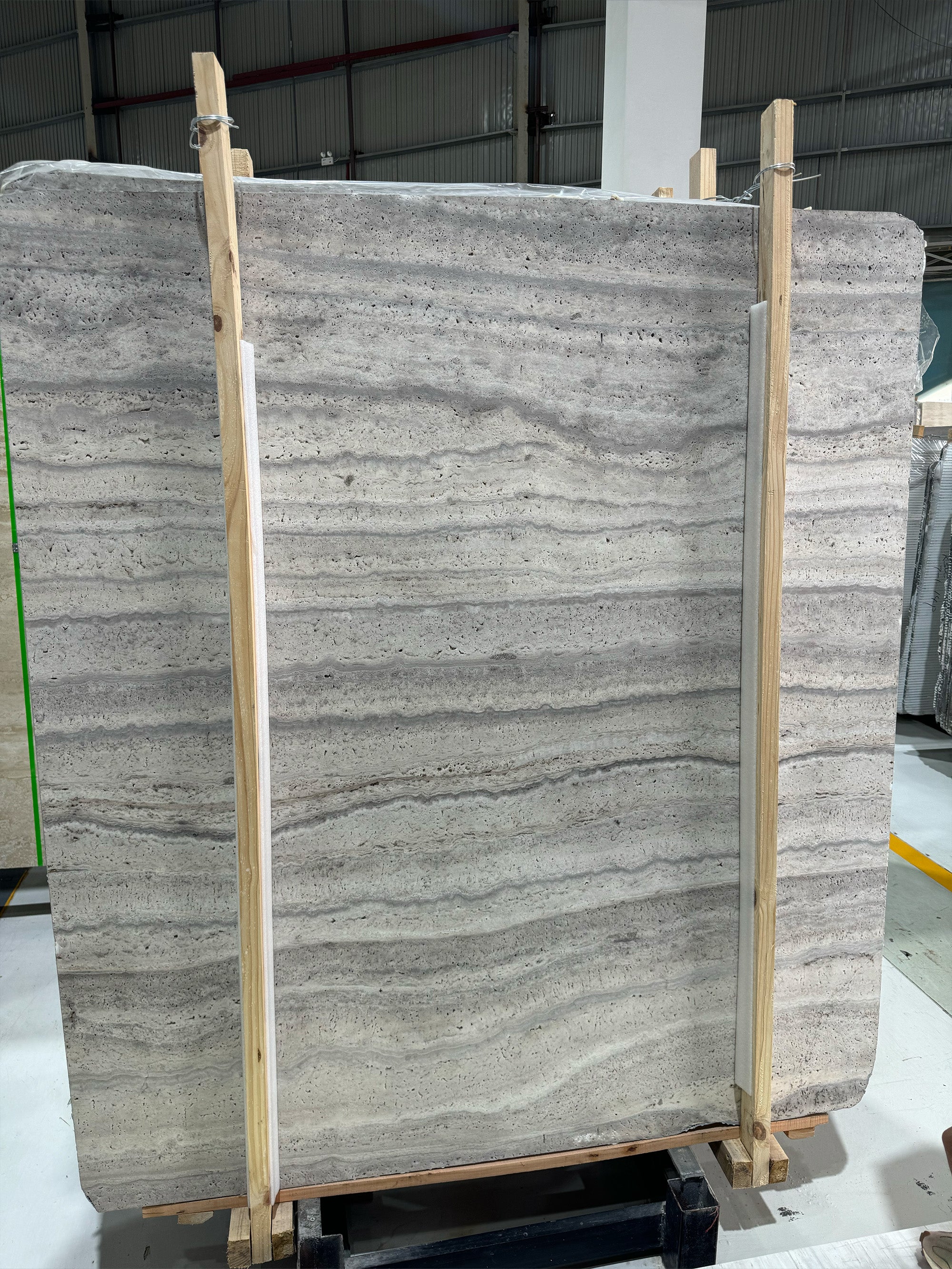 Modern Silver Travertine slab with a cool metallic ash and charcoal grey grain, perfect for brutalist-inspired vanities and sleek architectural surfaces.