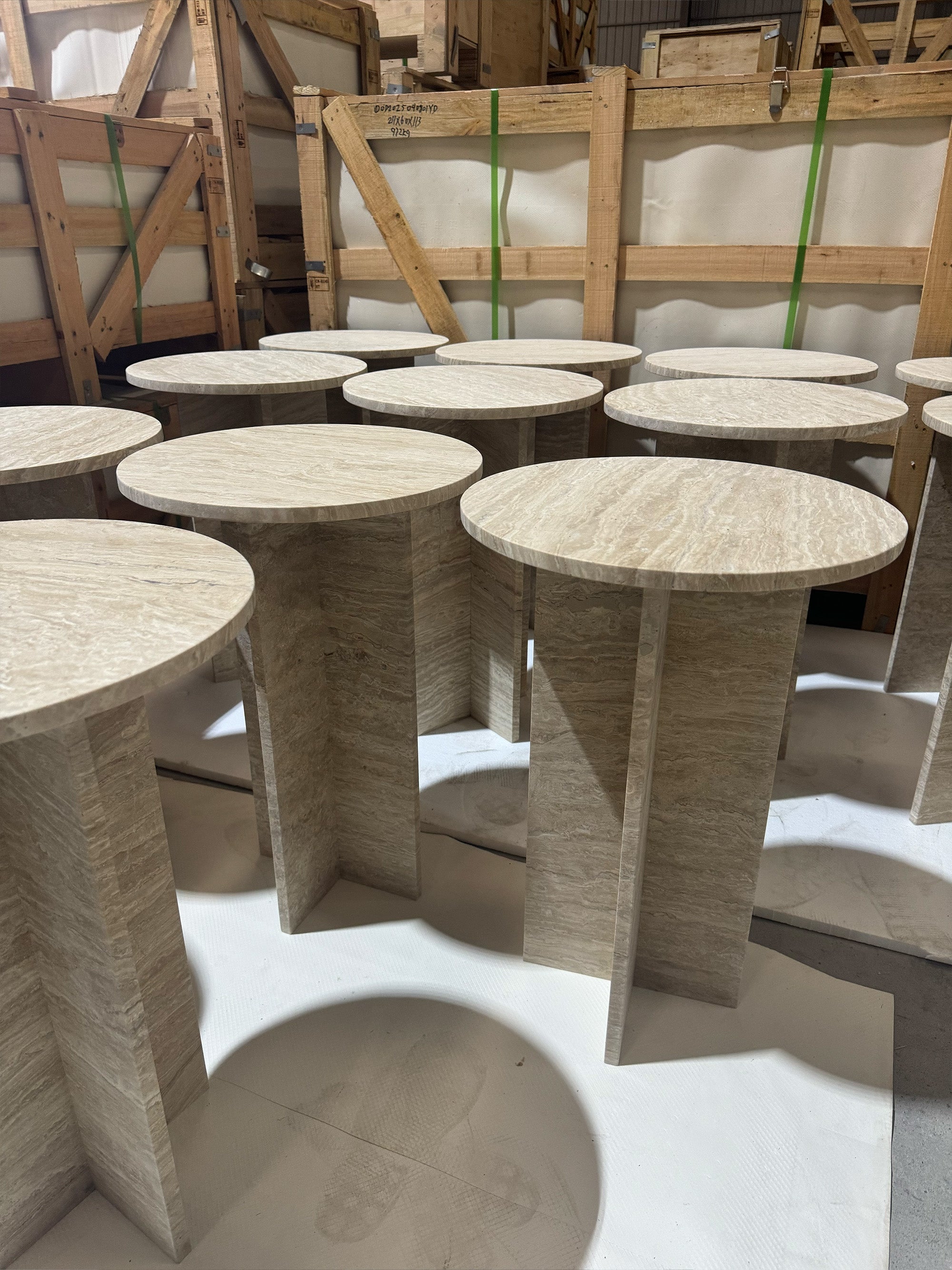 A diverse collection of modern marble furniture and fixtures including monolithic bathtubs and integrated stone sinks in premium Italian marble.