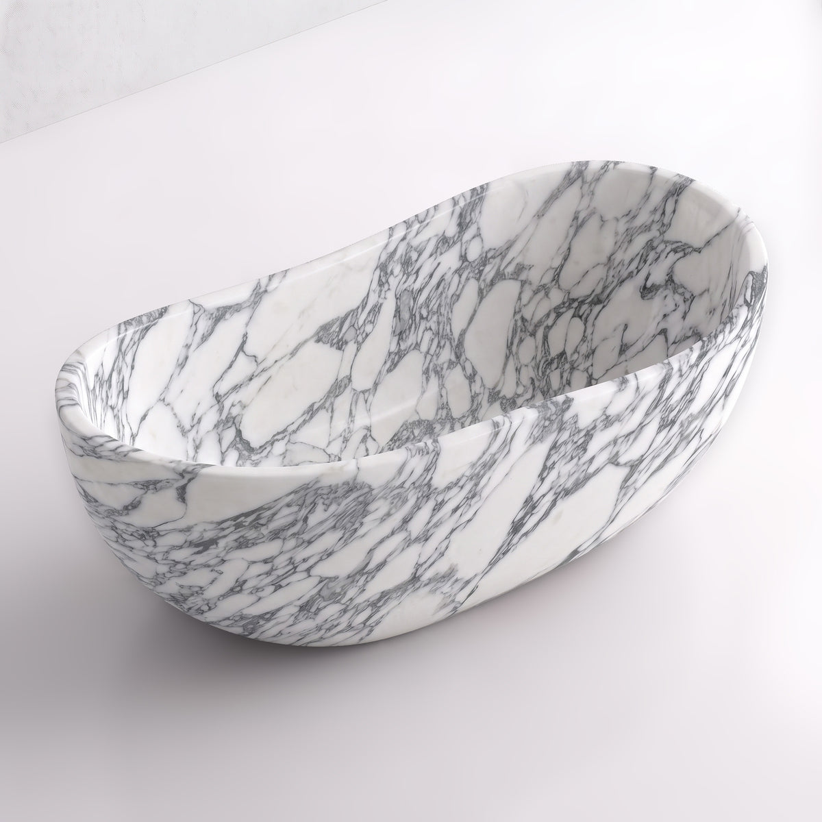 Elevated three-quarter perspective view of the Arabescato marble wave soaking tub, highlighting the asymmetrical undulating rim, seamless ergonomic interior, and fluid breccia veining flowing across the stone.