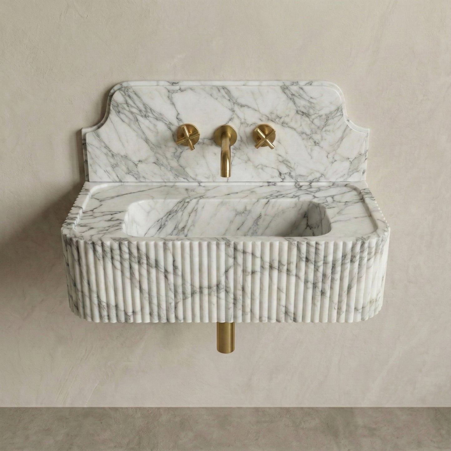 Front profile of a wall-mounted Arabescato marble washbasin featuring a decorative high backsplash, vertical ribbed texture, and signature grey brecciated veining.
