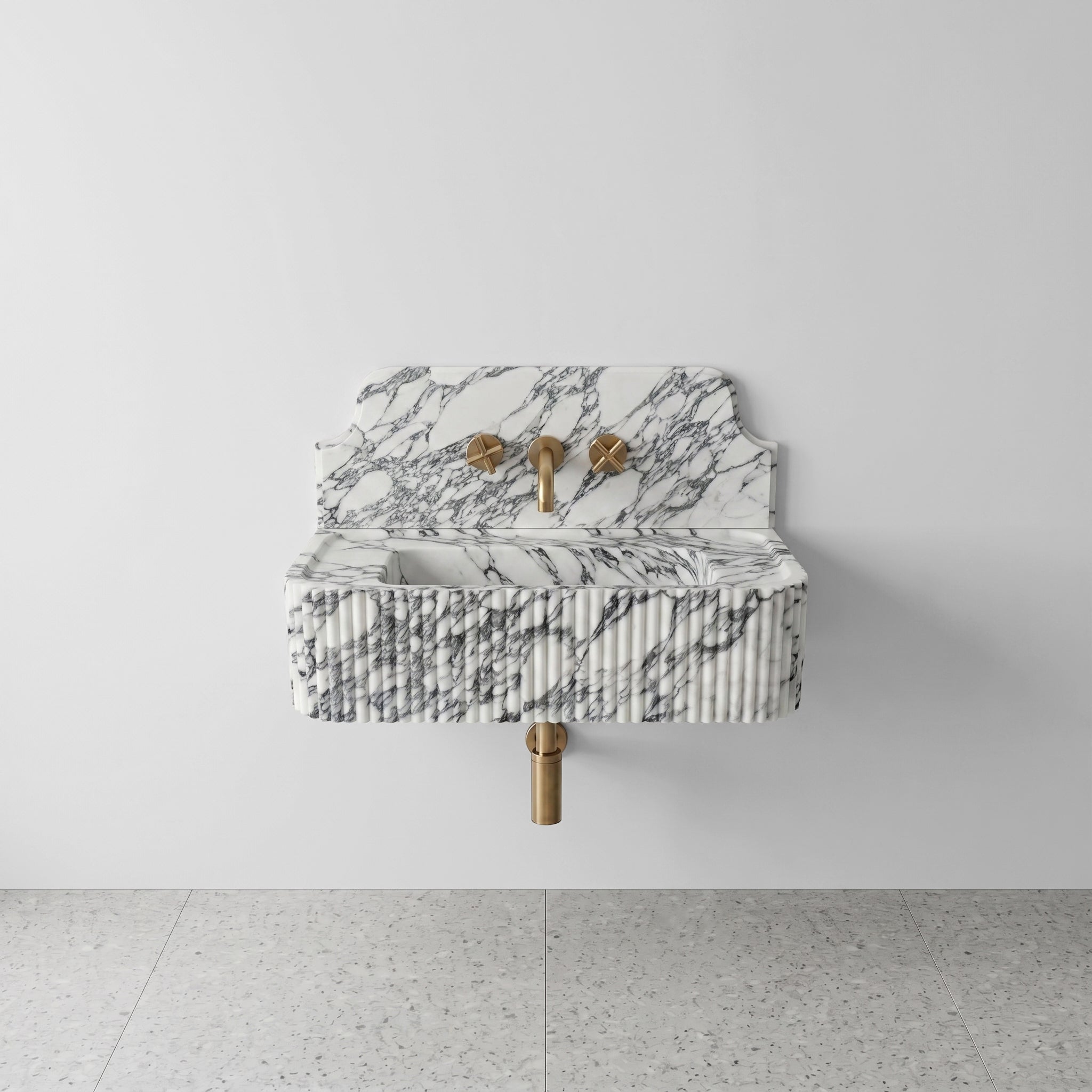 Front profile of a wall-mounted Arabescato marble washbasin featuring a decorative high backsplash, vertical ribbed texture, and signature grey brecciated veining.