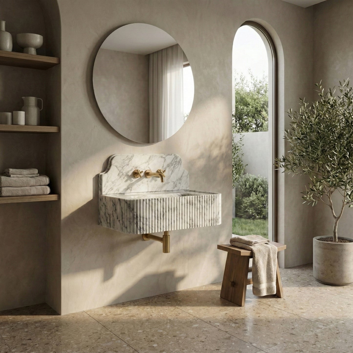 Tranquil luxury bathroom featuring a wall-mounted Arabescato marble sink with backsplash, paired with a round mirror, wooden accessories, and terrazzo flooring.