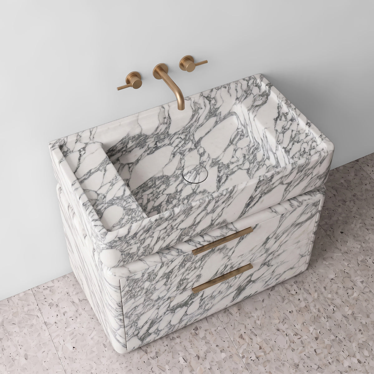 High-angle perspective view of the Arabescato marble double-drawer vanity, highlighting the integrated trough sink with a matching marble drain cover, raised border edge, curved drawer profiles, and brushed brass pulls.