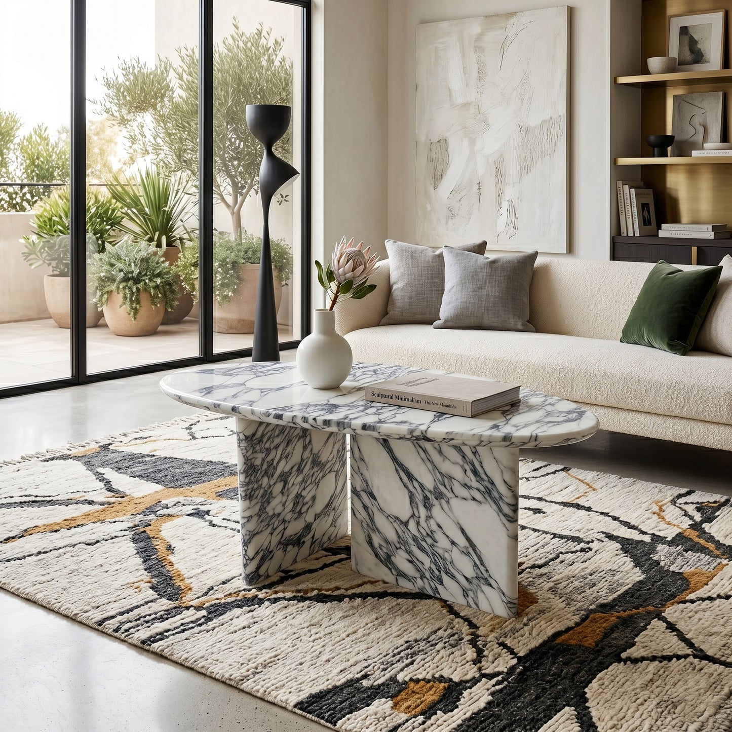 Luxury living room interior showcasing an oval Arabescato marble coffee table as a centerpiece on a patterned rug, styled with a cream sofa and contemporary decor.