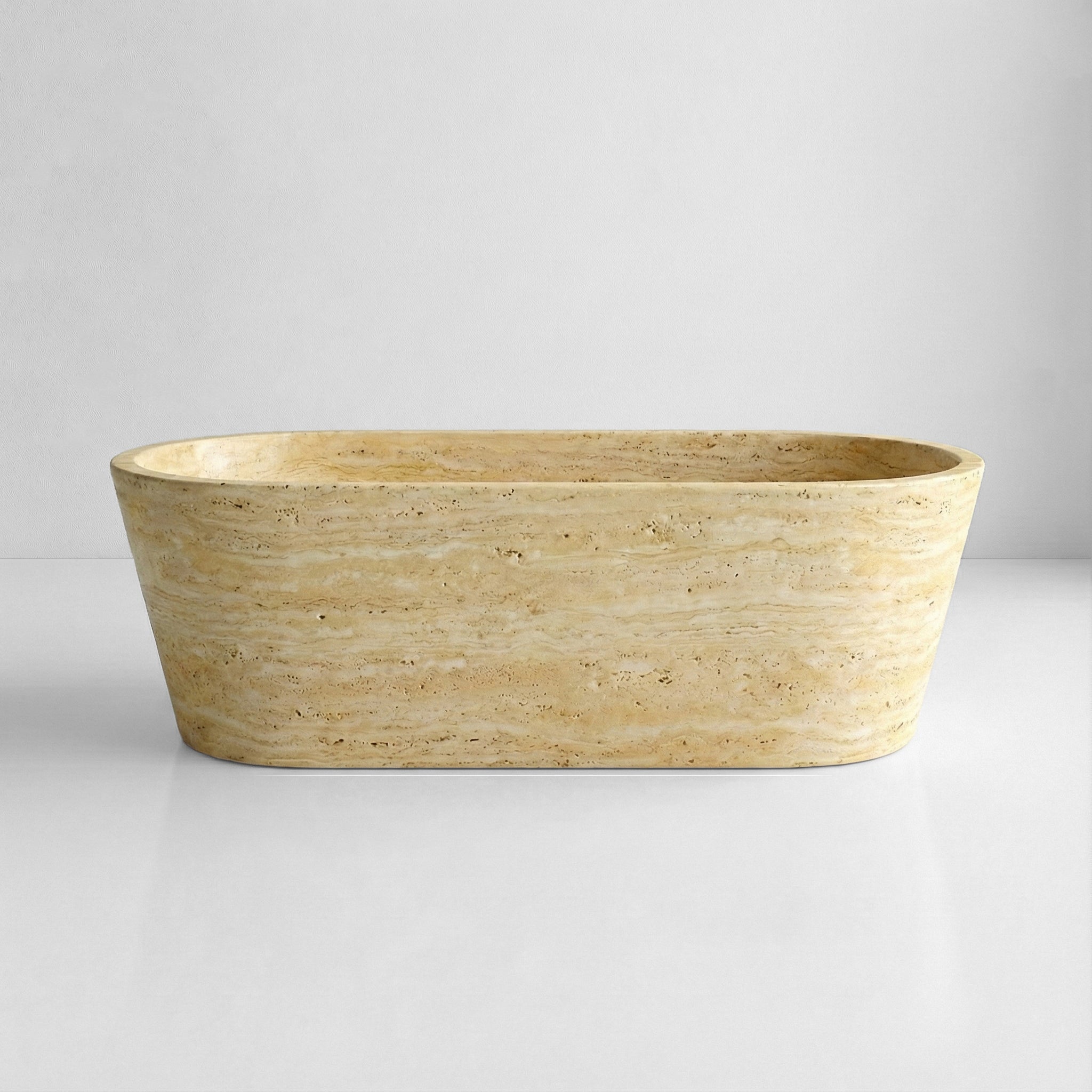 Front profile of a minimalist beige Travertine stone bathtub featuring a matte honed finish and warm, neutral earth tones.