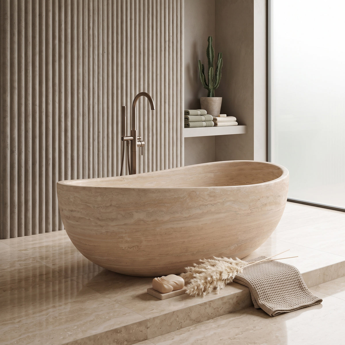Mediterranean spa-inspired bathroom interior featuring the freestanding Beige Travertine wave bathtub resting on a raised stone platform, paired with a floor-mounted brushed bronze tub filler, vertical fluted wall cladding, and earthy minimalist decor.