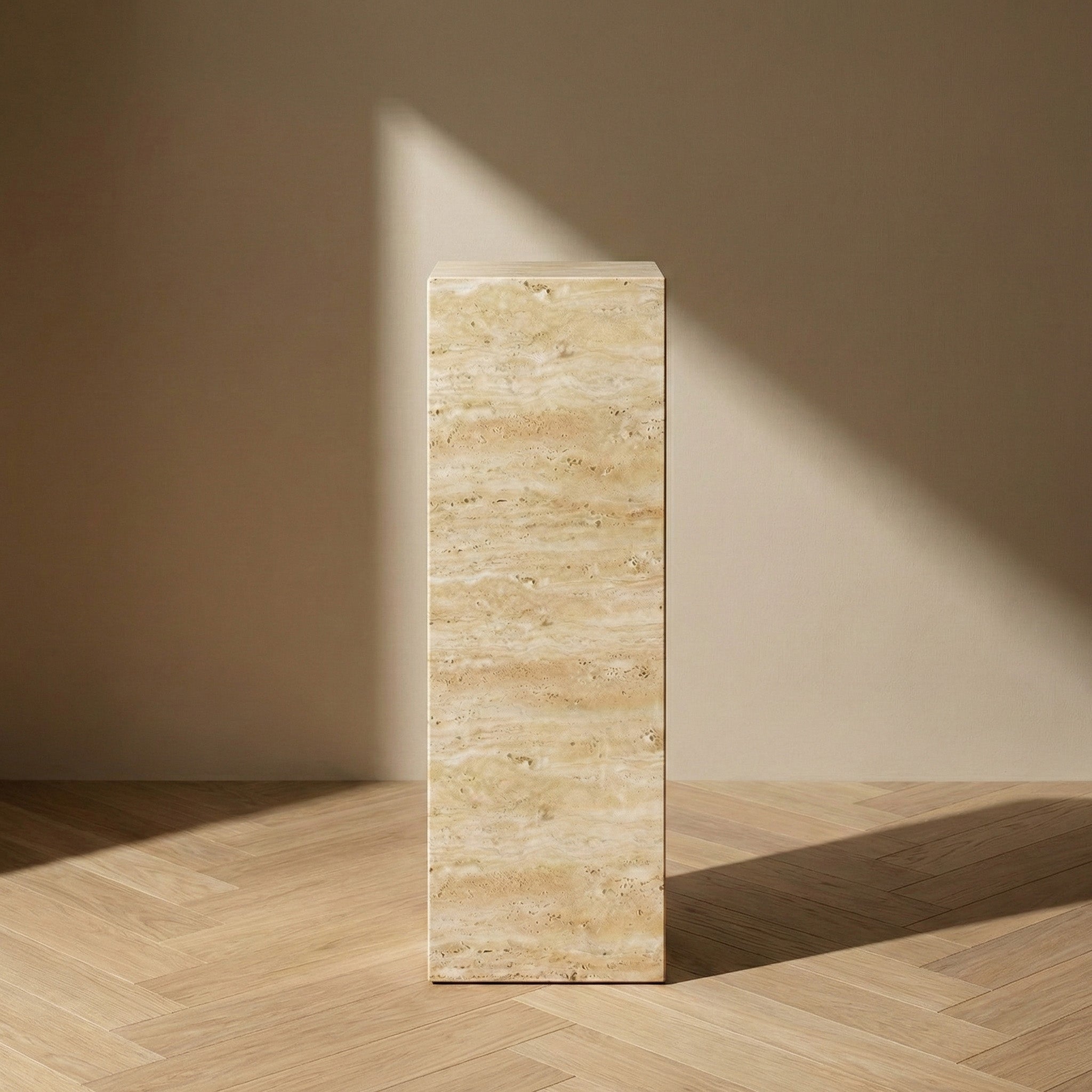 A clean, front-facing view of a Beige Travertine pedestal stand against a neutral wall, showcasing the beautiful horizontal veining and natural variations of the cream-colored stone.