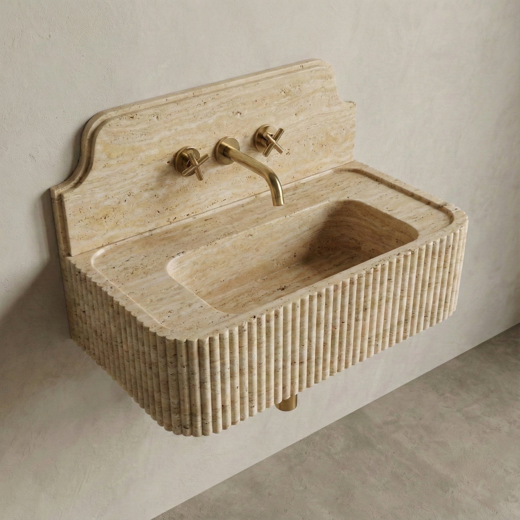 High-angle side view of a vintage-inspired Beige Travertine sink, showcasing the curved stone backsplash, fluted apron, and matte honed finish.