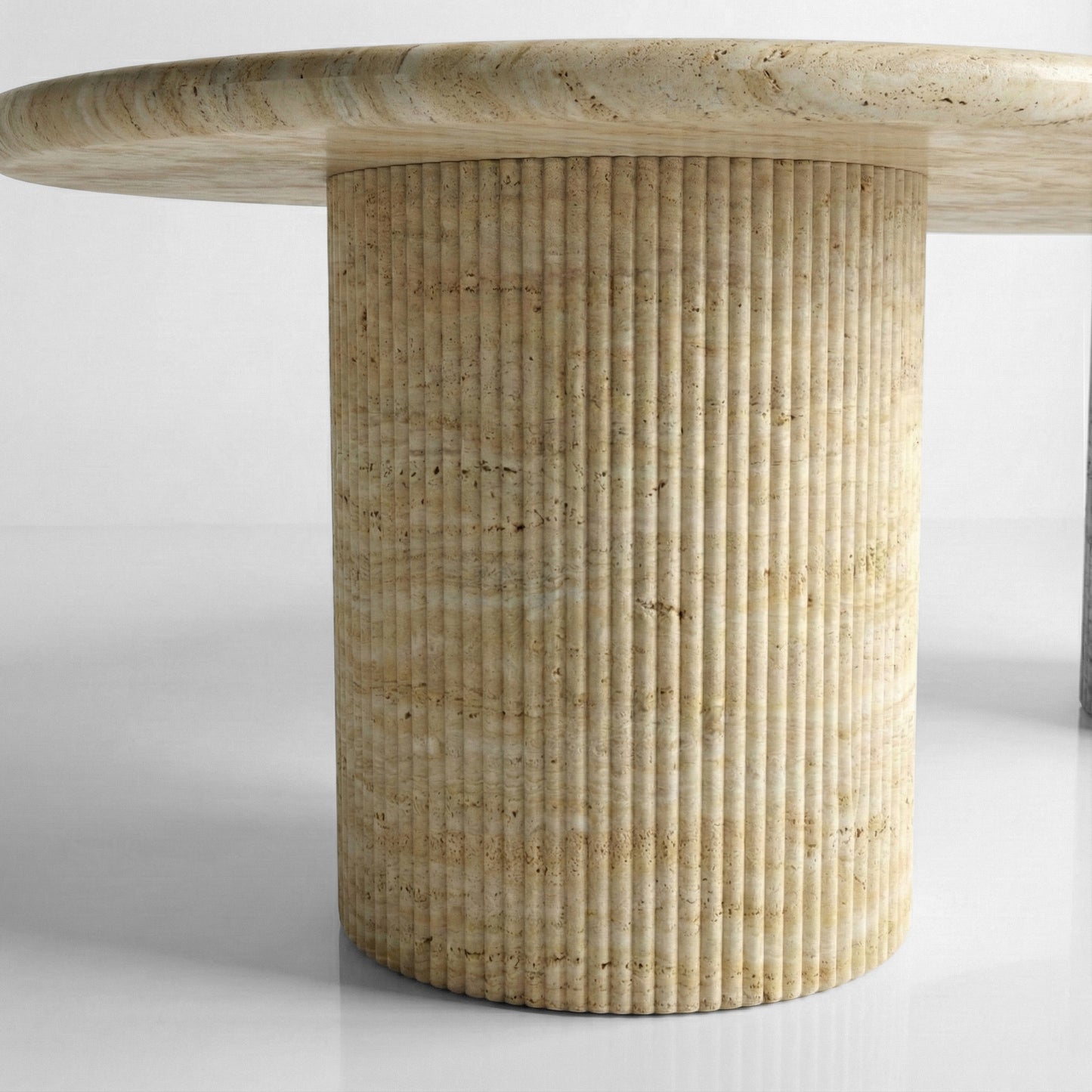 Detail shot of a ribbed column table base crafted from natural Beige Travertine, showcasing the vertical fluting and warm sandy mineral hues.