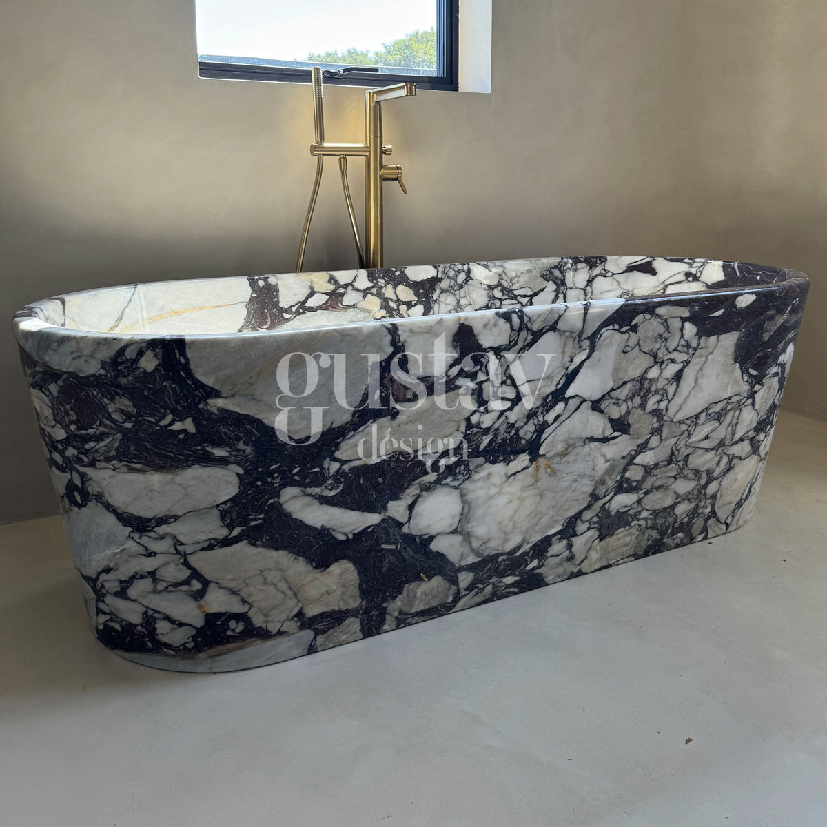 Side profile of a handcrafted Calacatta Viola marble bathtub resting on a pallet, displaying the unique purple and white mineral patterns.