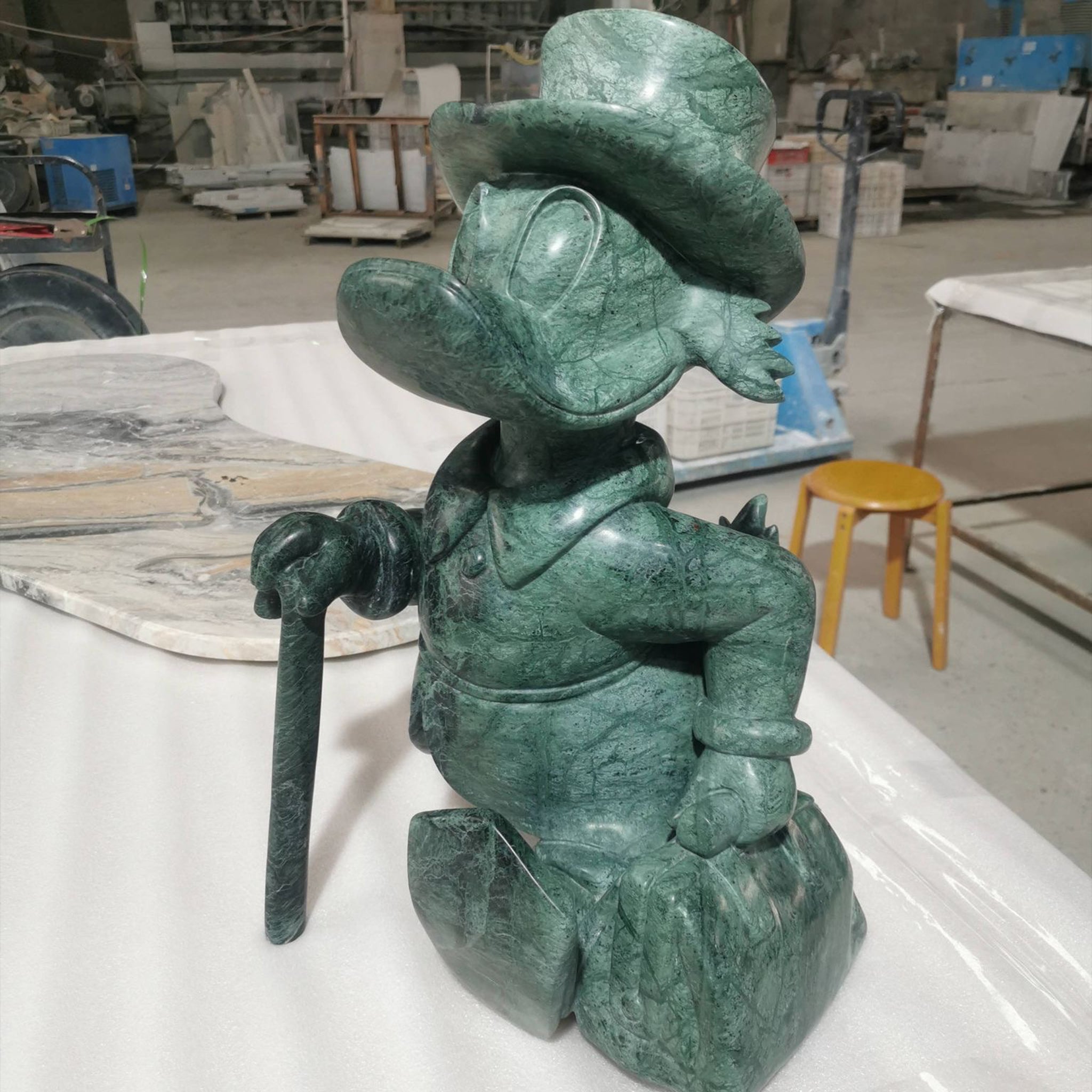 Intricate custom stone sculpture of a cartoon character hand-carved from solid Green Guatemala marble, demonstrating high-detail artistic capabilities.