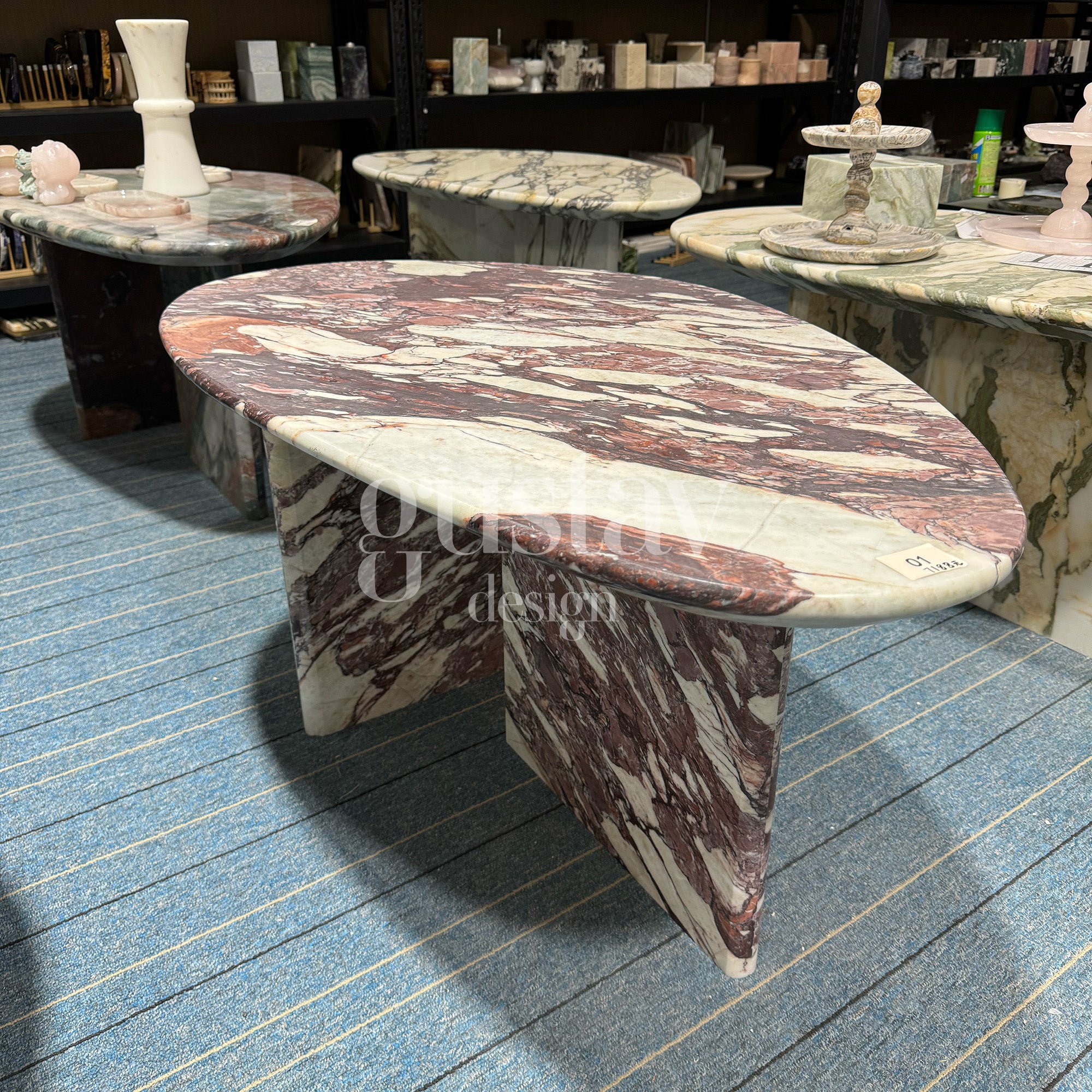 Oval Calacatta Viola marble coffee table featuring bold purple and burgundy veining on a white background, signature furniture by Gustav Design.