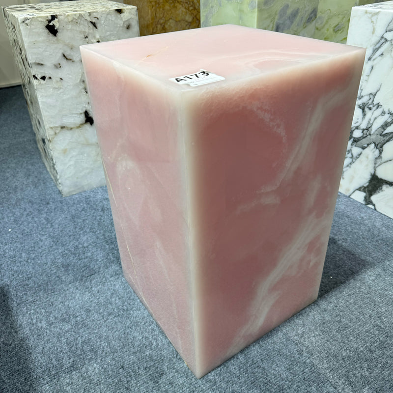 A solid pink onyx plinth side table featuring unique natural translucency and polished finish, handcrafted as a luxury interior accent piece by GustavDesign.