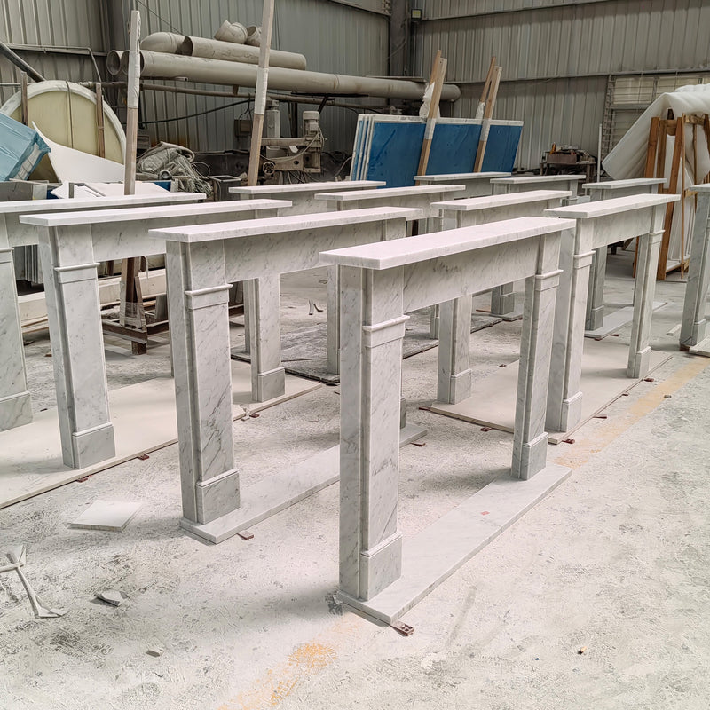 Multiple custom white marble fireplace surrounds with a minimalist modern design, precision-fabricated in the factory for luxury residential interiors by GustavDesign.