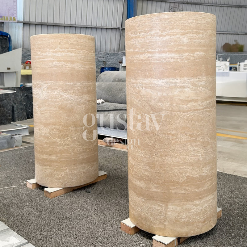 Pair of large cylindrical beige travertine pedestal sinks, handcrafted natural stone plinths by Gustav Design.