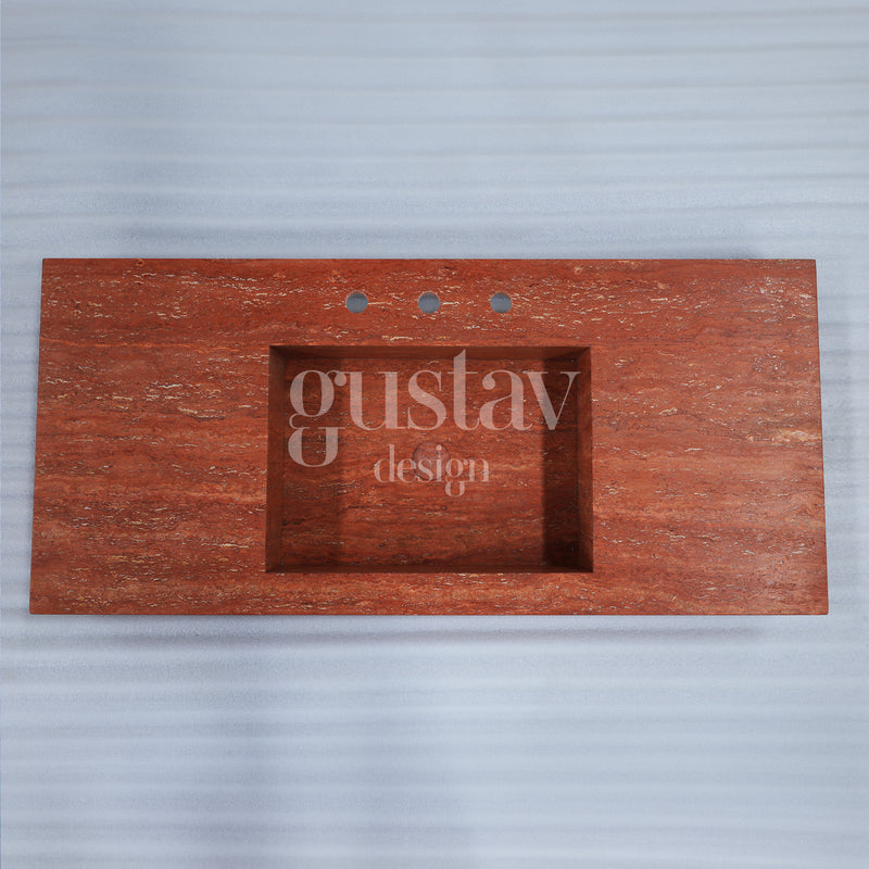 Top-down view of a rectangular red travertine sink and vanity top with three faucet holes, natural terracotta stone by Gustav Design.