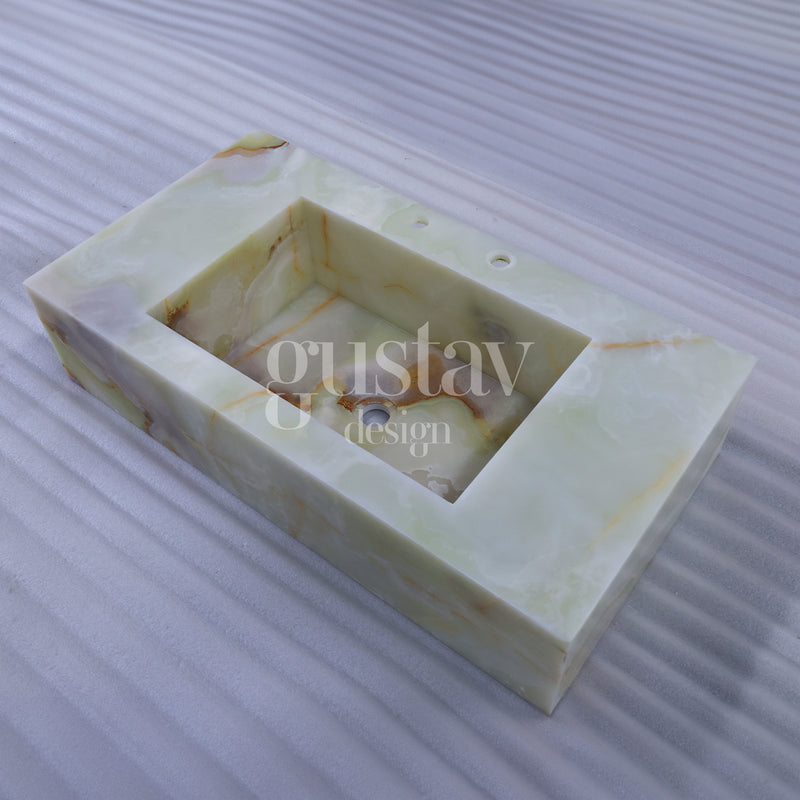 Custom rectangular green onyx stone sink featuring natural honey and brown veining, bespoke luxury washbasin by Gustav Design.