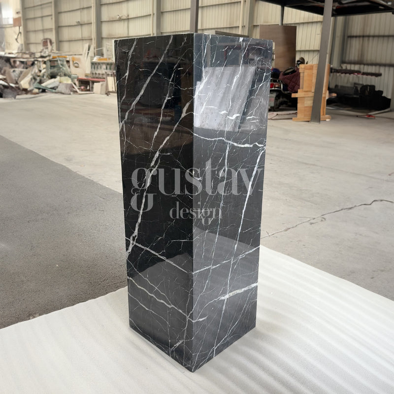 Polished Nero Marquina marble pedestal plinth with striking white veining, luxury stone display stand by Gustav Design.
