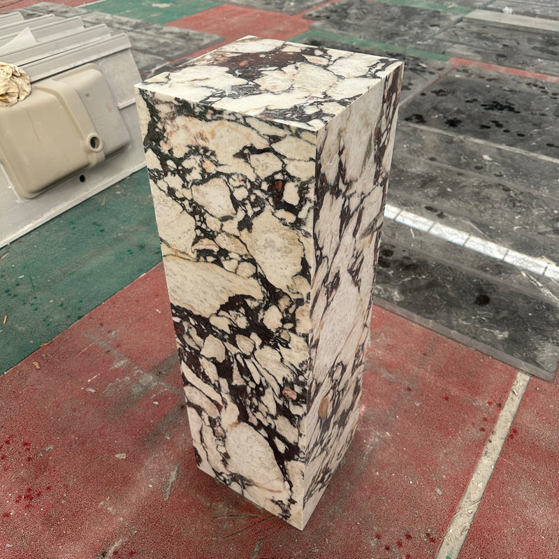 Custom square pedestal plinth fabricated from Calacatta Viola marble, highlighting the stone's brecciated texture for art display.