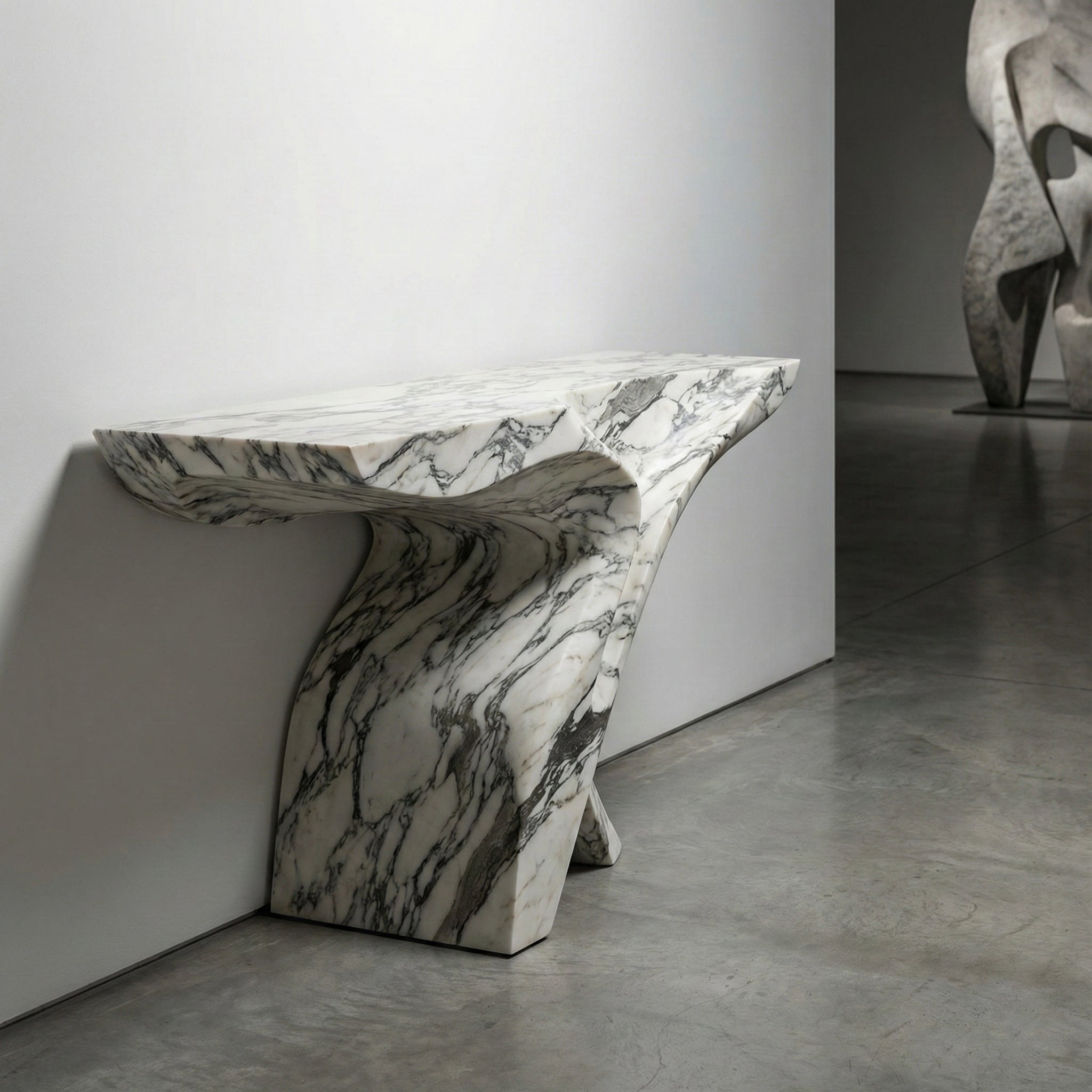 Avant-garde bespoke marble console table featuring a fluid, twisted design carved from solid white Arabescato stone, displayed in a gallery setting.