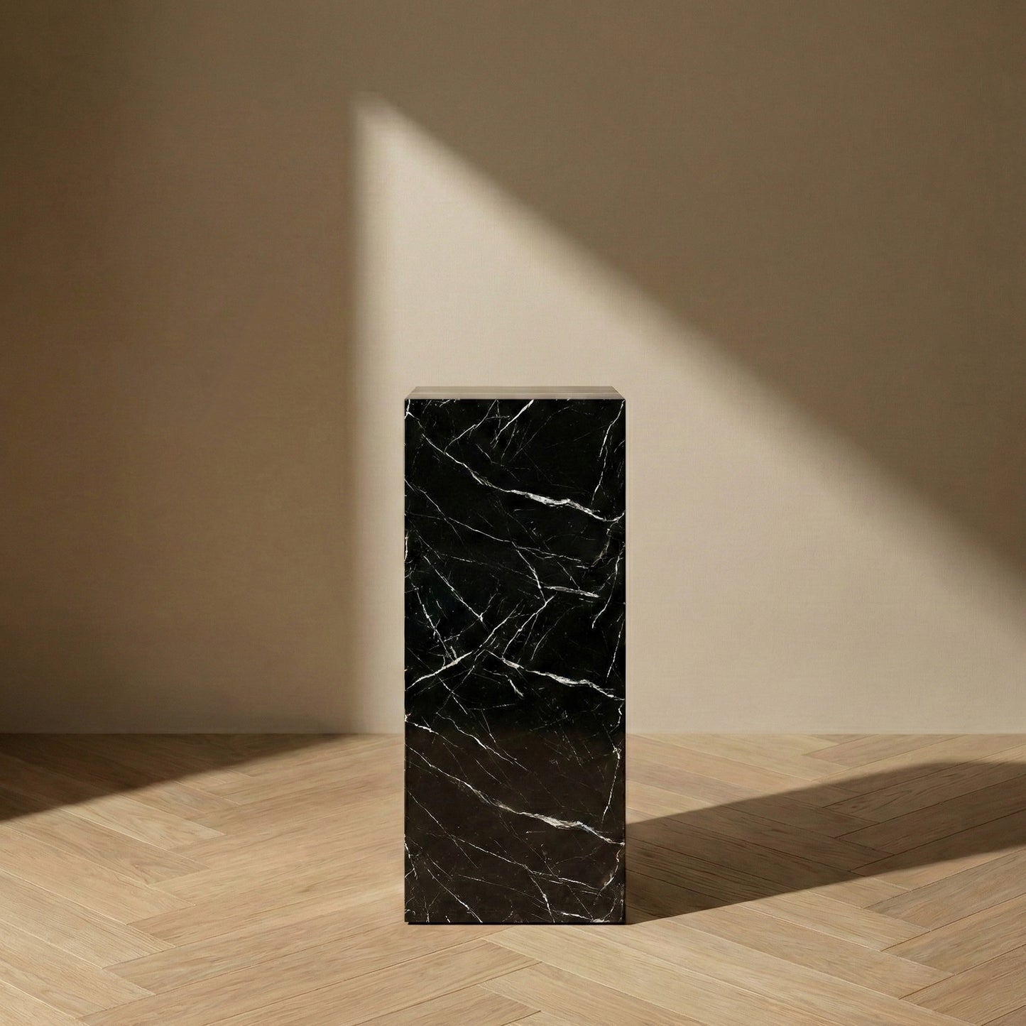 Nero Marquina black marble pedestal stand in a minimalist gallery style for luxury home decor.