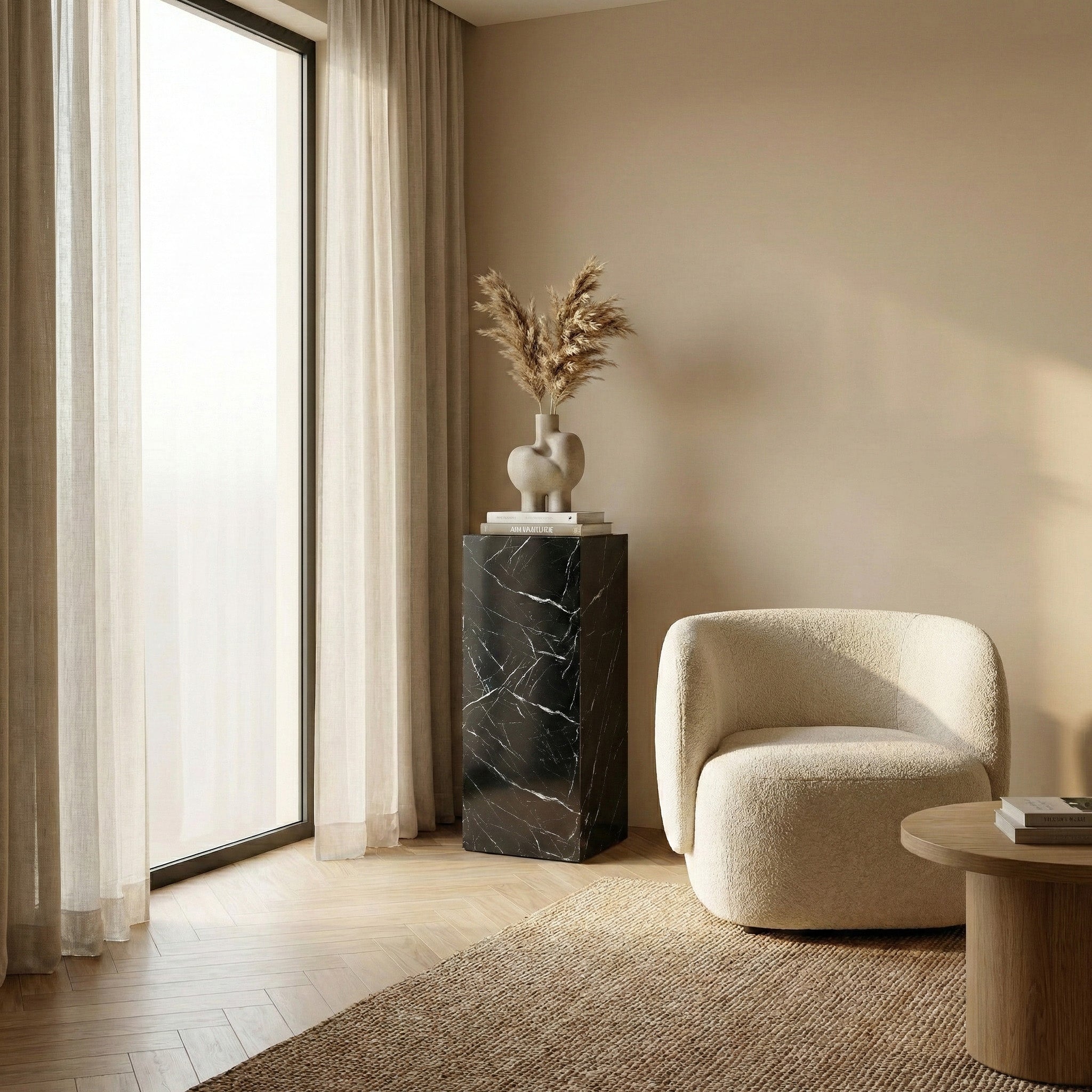 Modern living room interior with a 35-inch black marble pedestal stand used as an art stand for a sculptural vase.