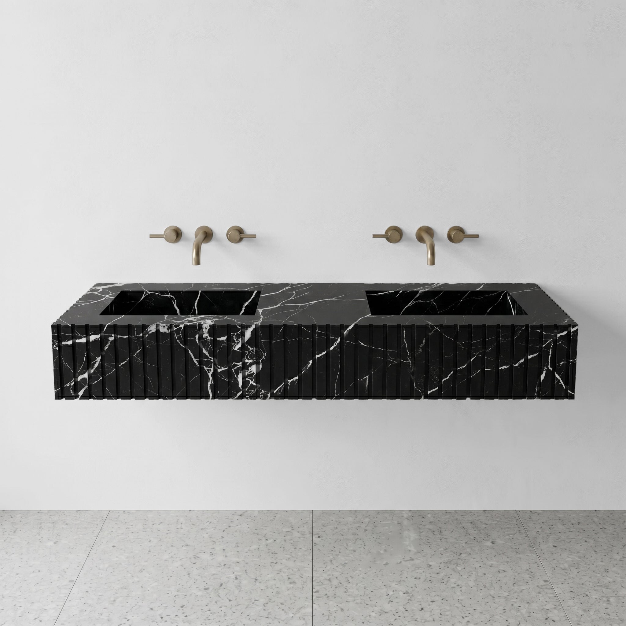 Front profile of a floating double vanity crafted from Nero Marquina marble, featuring a custom ribbed stone apron and striking white lightning veins on black stone.