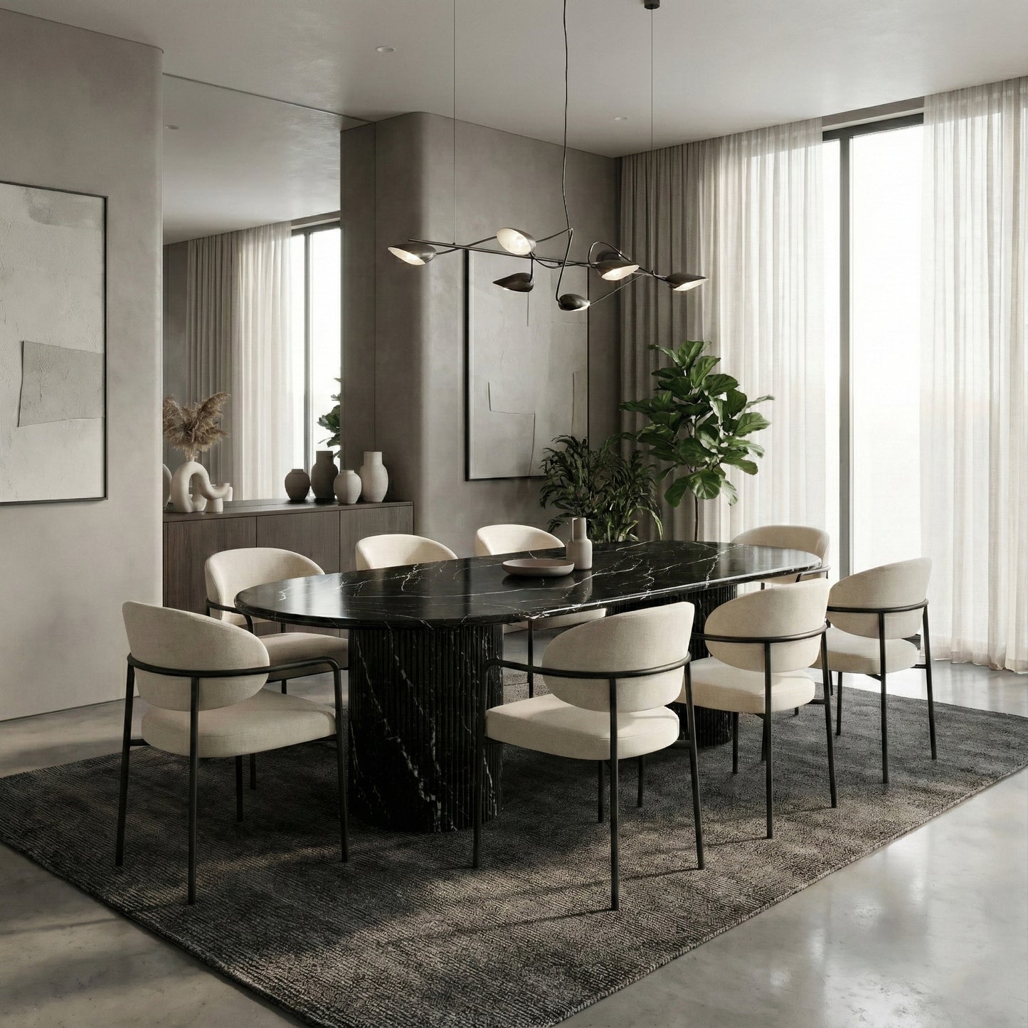 Modern luxury dining room featuring a statement Black Marquina marble oval table, paired with light cream dining chairs and a sculptural chandelier for high contrast.