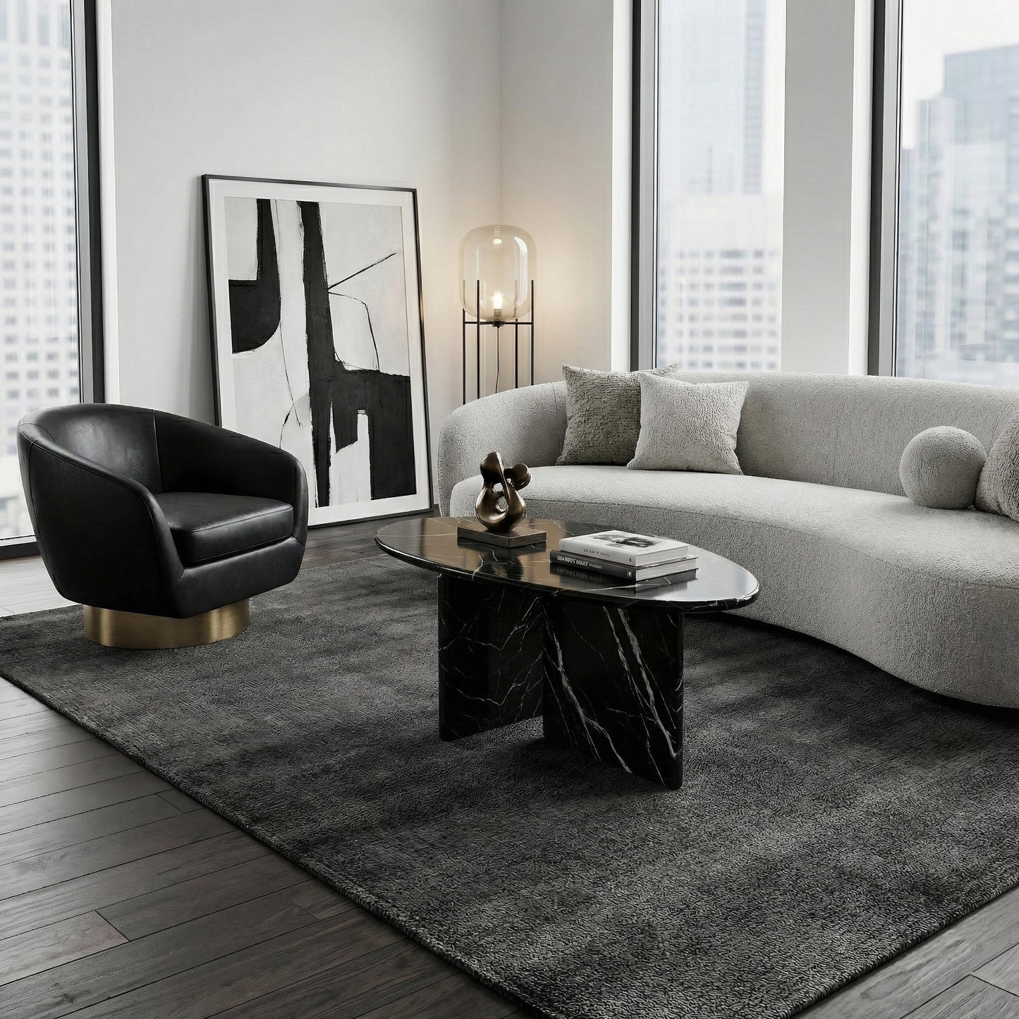 Modern high-rise living room featuring an oval Black Marquina marble coffee table styled on a plush grey rug with a curved sofa and a black leather accent chair.