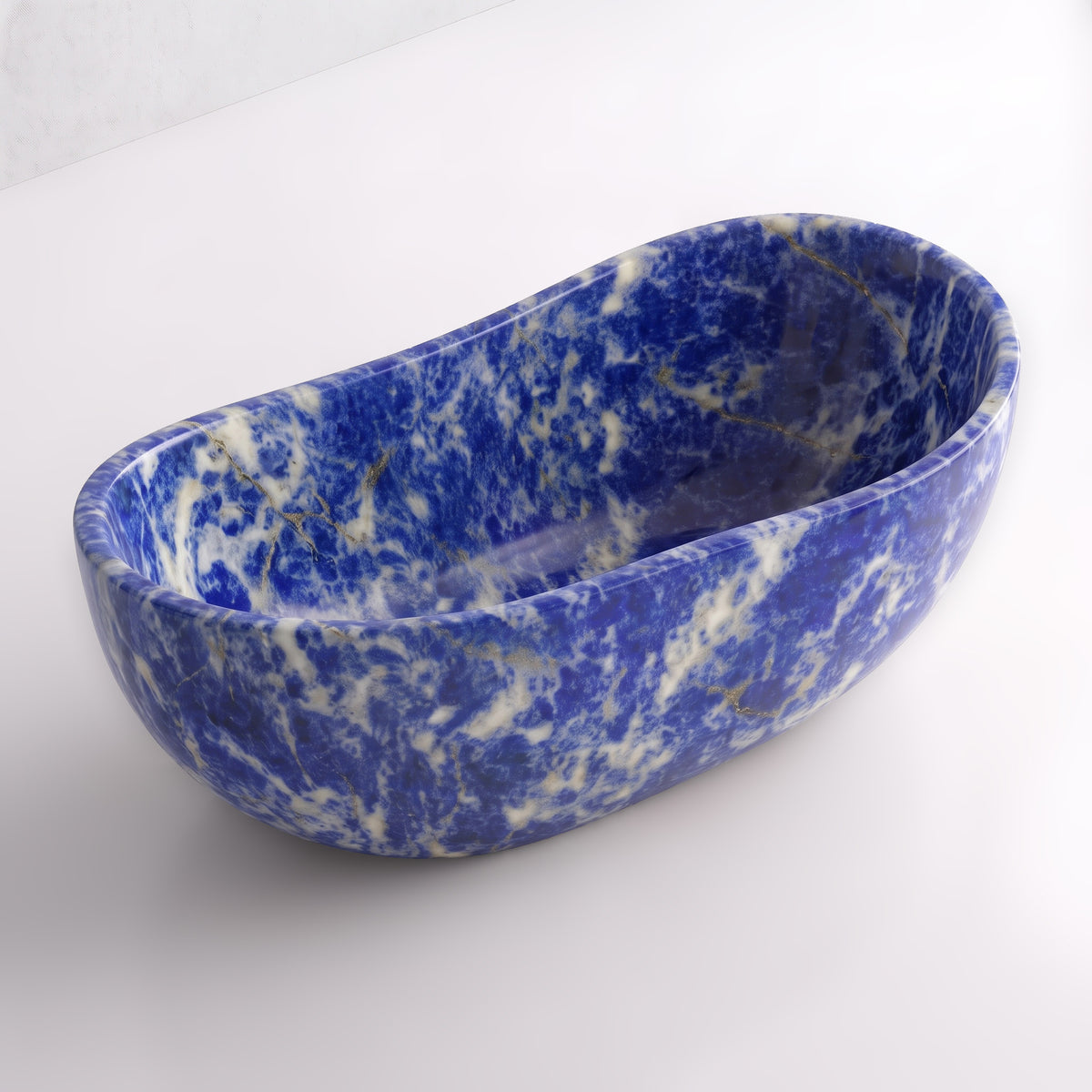 Elevated three-quarter perspective view of the Blue Sodalite marble wave soaking tub, highlighting the asymmetrical undulating rim, seamless solid-carved interior, and deep ultramarine mineral patterns.