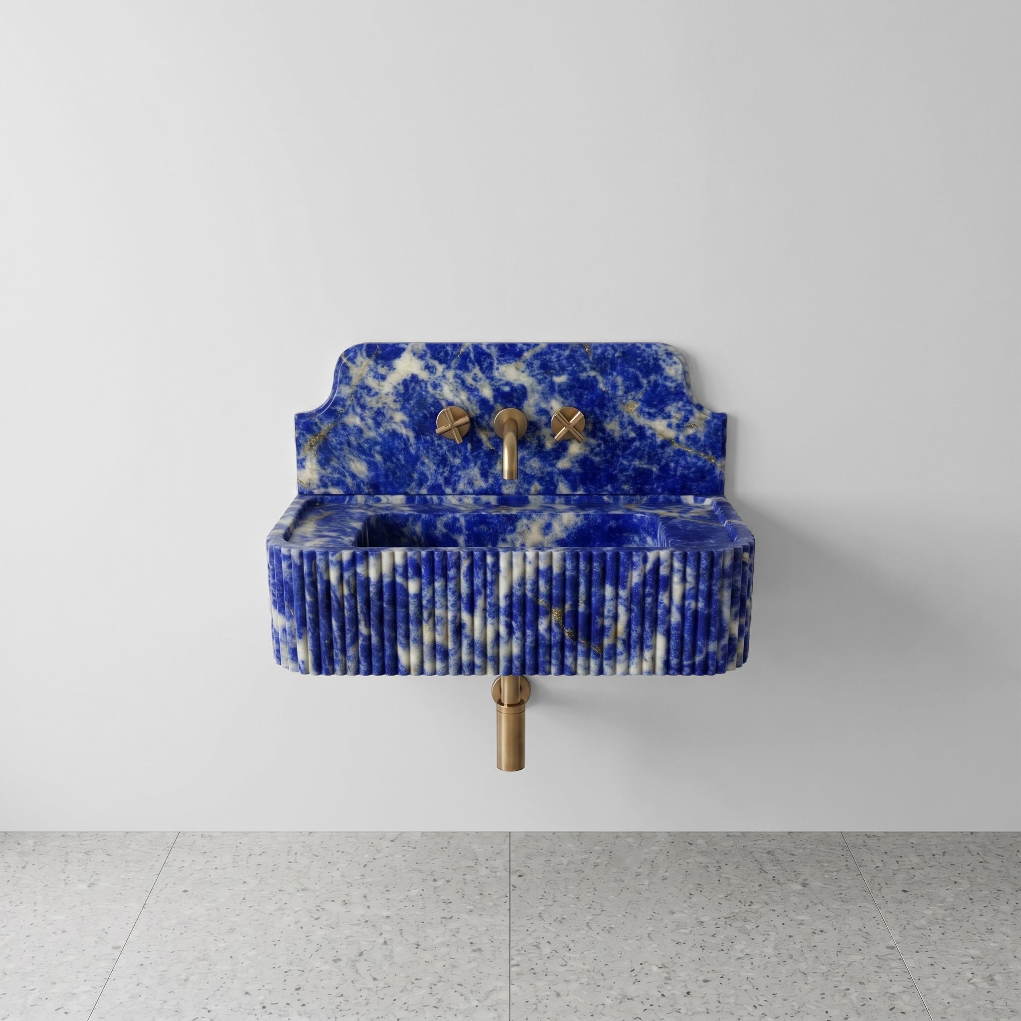 Front profile of a wall-mounted Blue Sodalite gemstone washbasin featuring a decorative high backsplash, vertical ribbed texture, and deep royal blue stone with gold pyrite inclusions.