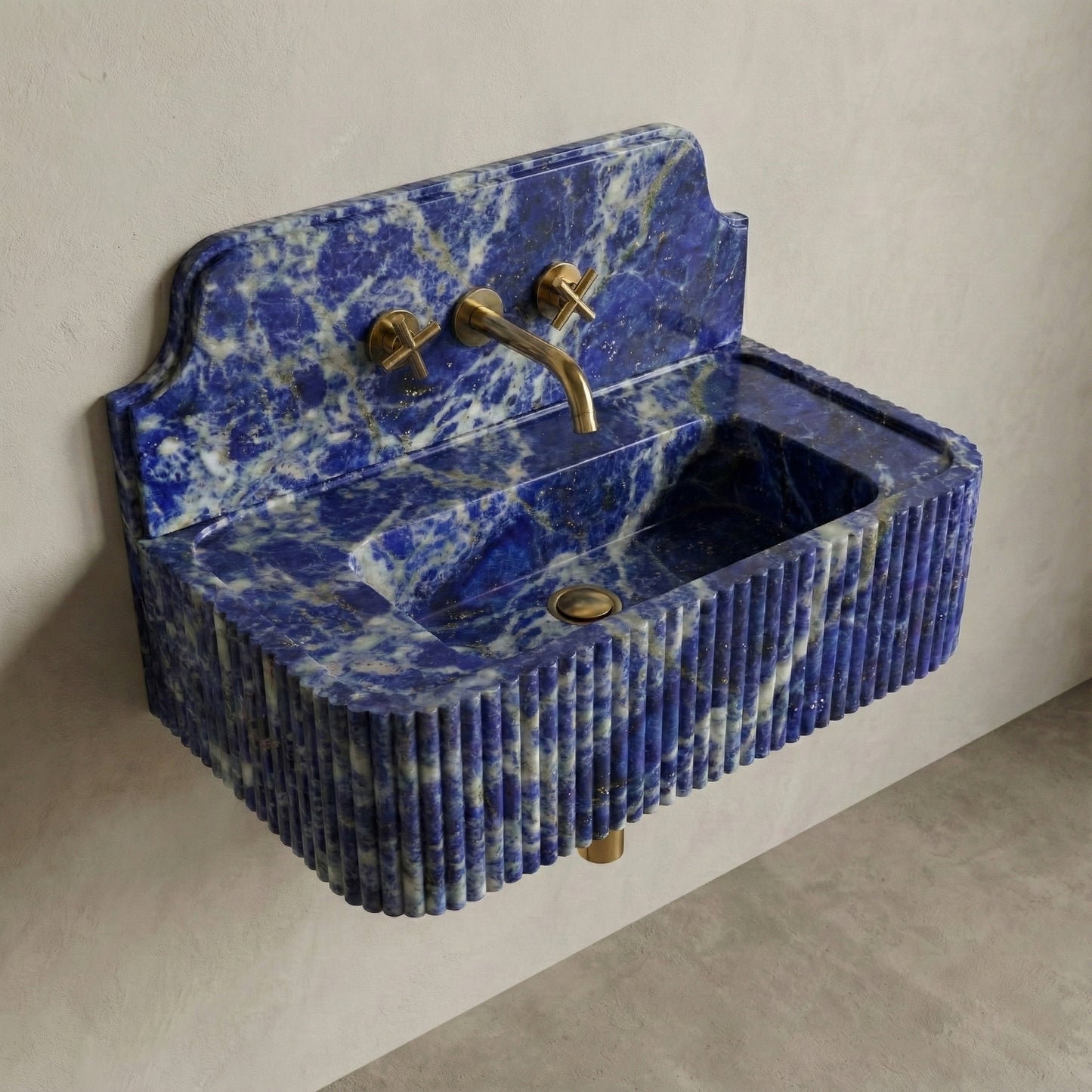 High-angle side view of a vintage-inspired Blue Sodalite sink, showcasing the curved stone backsplash, fluted apron, and vibrant semi-precious blue surface.