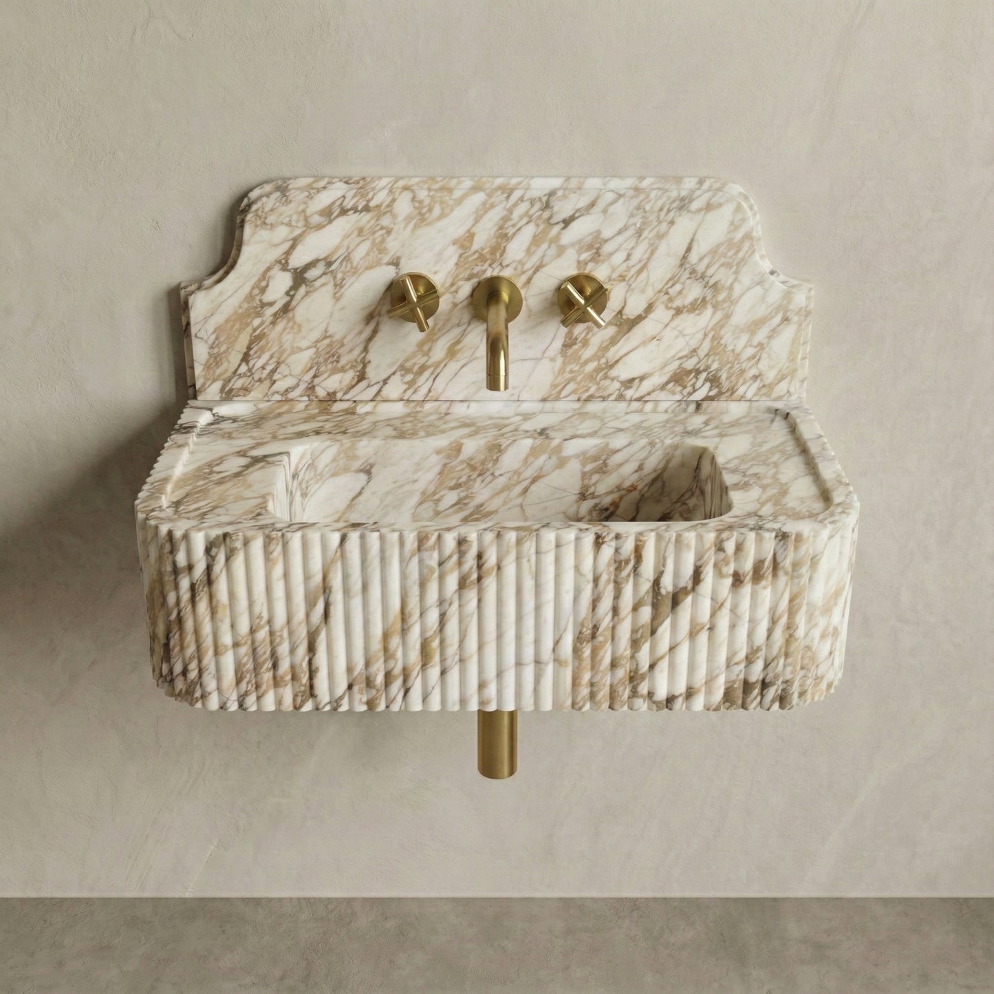 Front profile of a wall-mounted Calacatta Gold marble washbasin featuring a decorative high backsplash, vertical ribbed texture, and warm golden-grey veining.