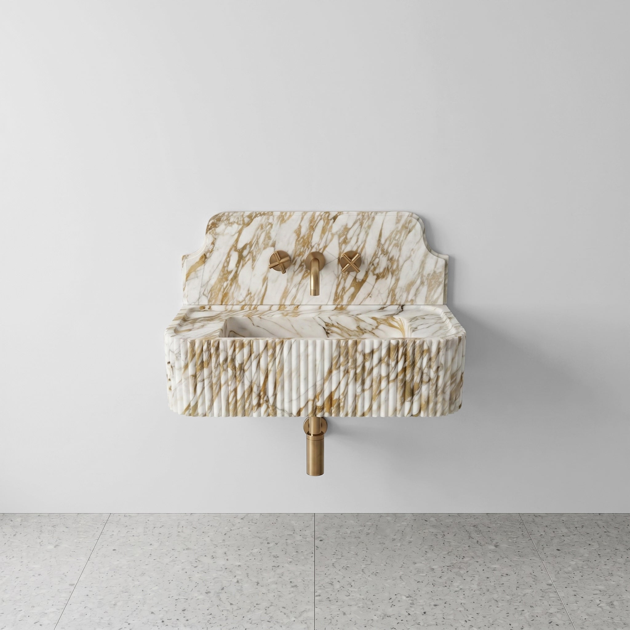 Front profile of a wall-mounted Calacatta Gold marble washbasin featuring a decorative high backsplash, vertical ribbed texture, and warm golden-grey veining.