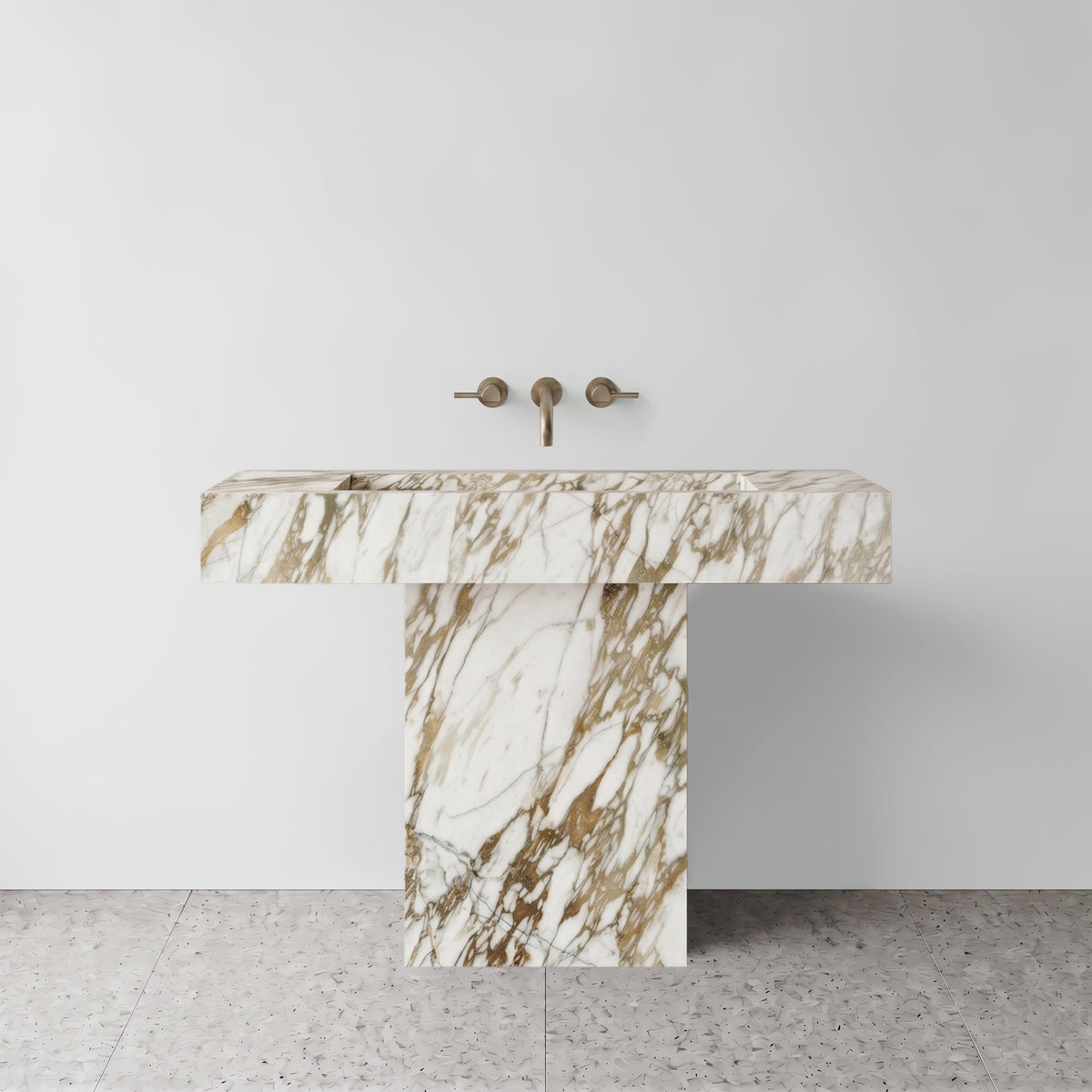 Front view of the Calacatta Gold marble T-shape pedestal sink highlighting its cantilevered basin and hollow plinth base.
