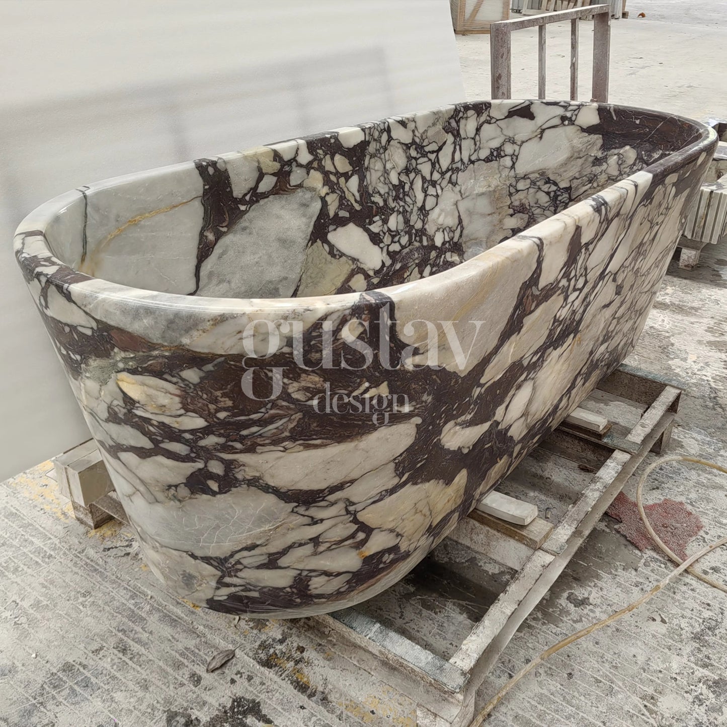 Side view of a freestanding Calacatta Viola Extra marble bathtub, highlighting the bold, chaotic purple veining and polished natural stone finish.
