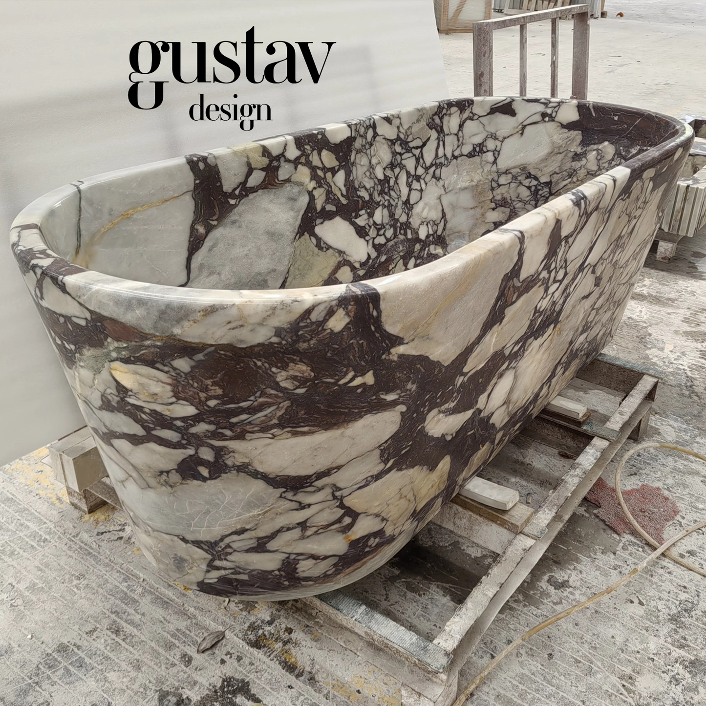 Side view of a freestanding Calacatta Viola Extra marble bathtub, highlighting the bold, chaotic purple veining and polished natural stone finish.