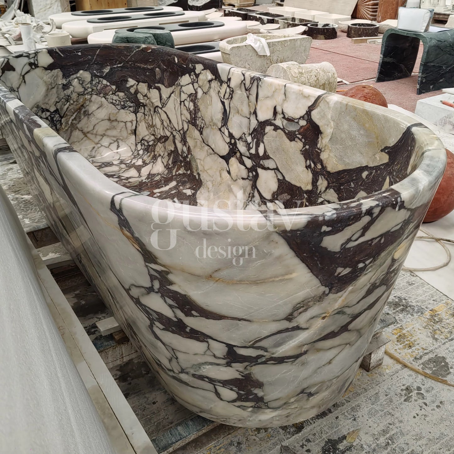 Side view of a freestanding Calacatta Viola Extra marble bathtub, highlighting the bold, chaotic purple veining and polished natural stone finish.