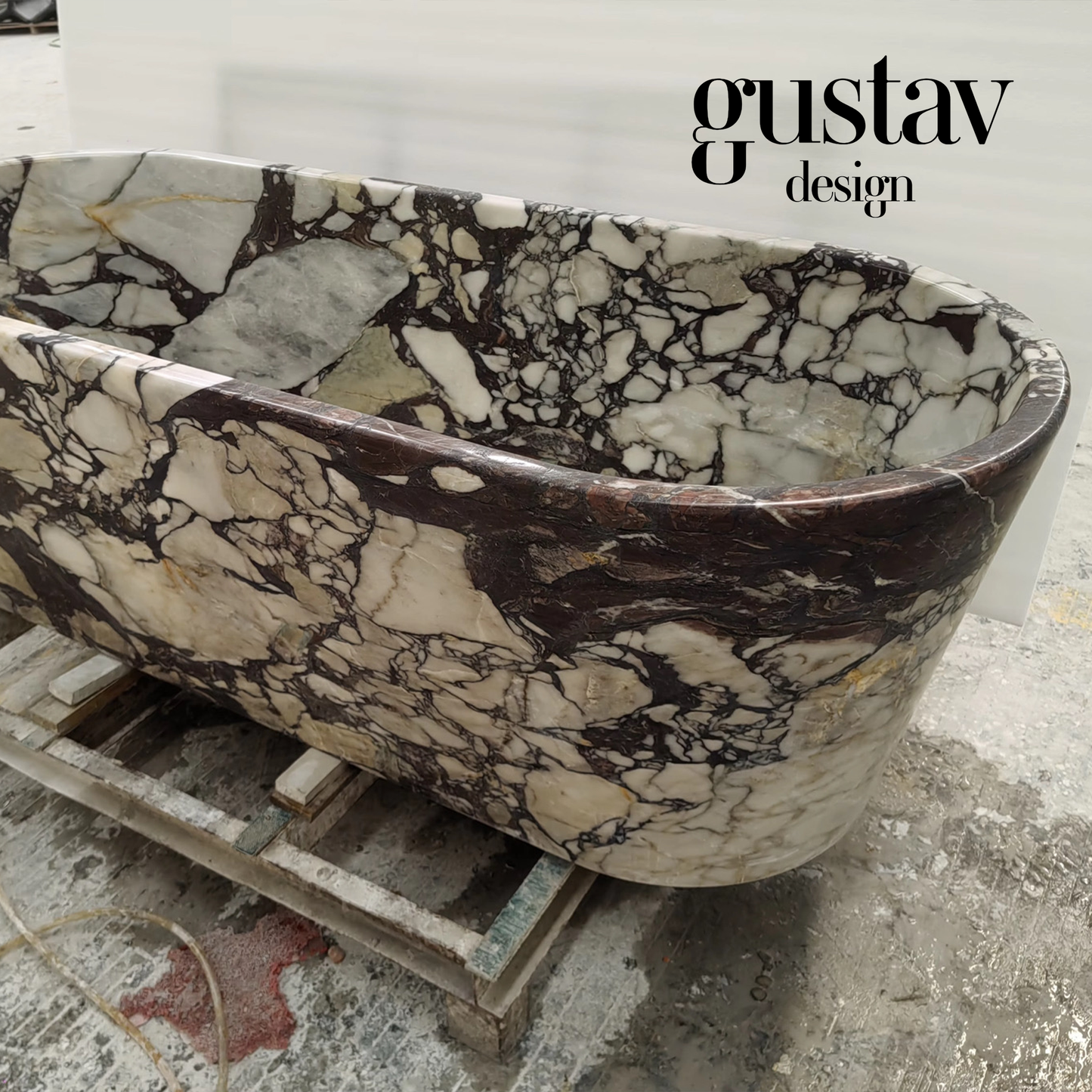 Close-up detail of a Calacatta Viola Extra bathtub rim, showing the intricate, high-contrast brecciated texture and rich wine-colored mineral deposits.