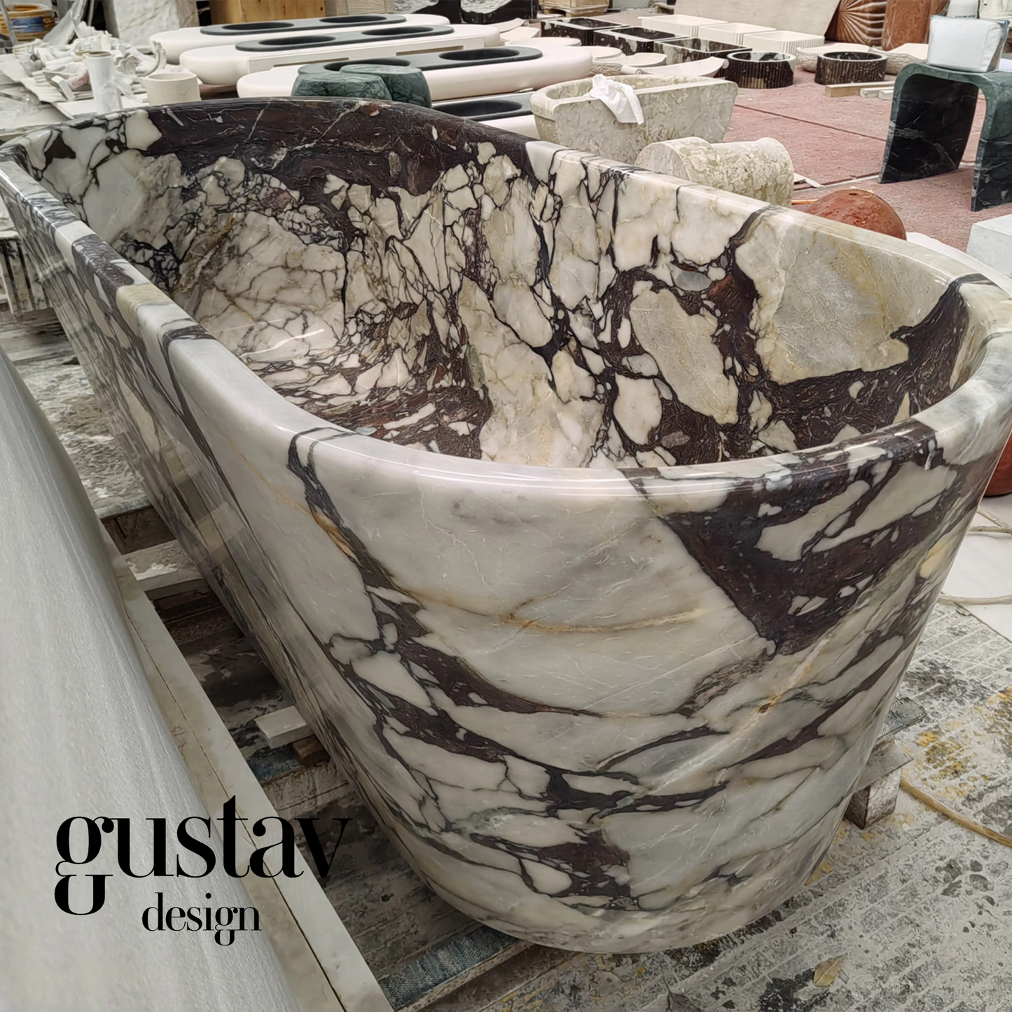 Perspective view of a massive Calacatta Viola Extra marble bathtub, emphasizing its heavy gauge stone construction and luxurious, deep soaking depth.
