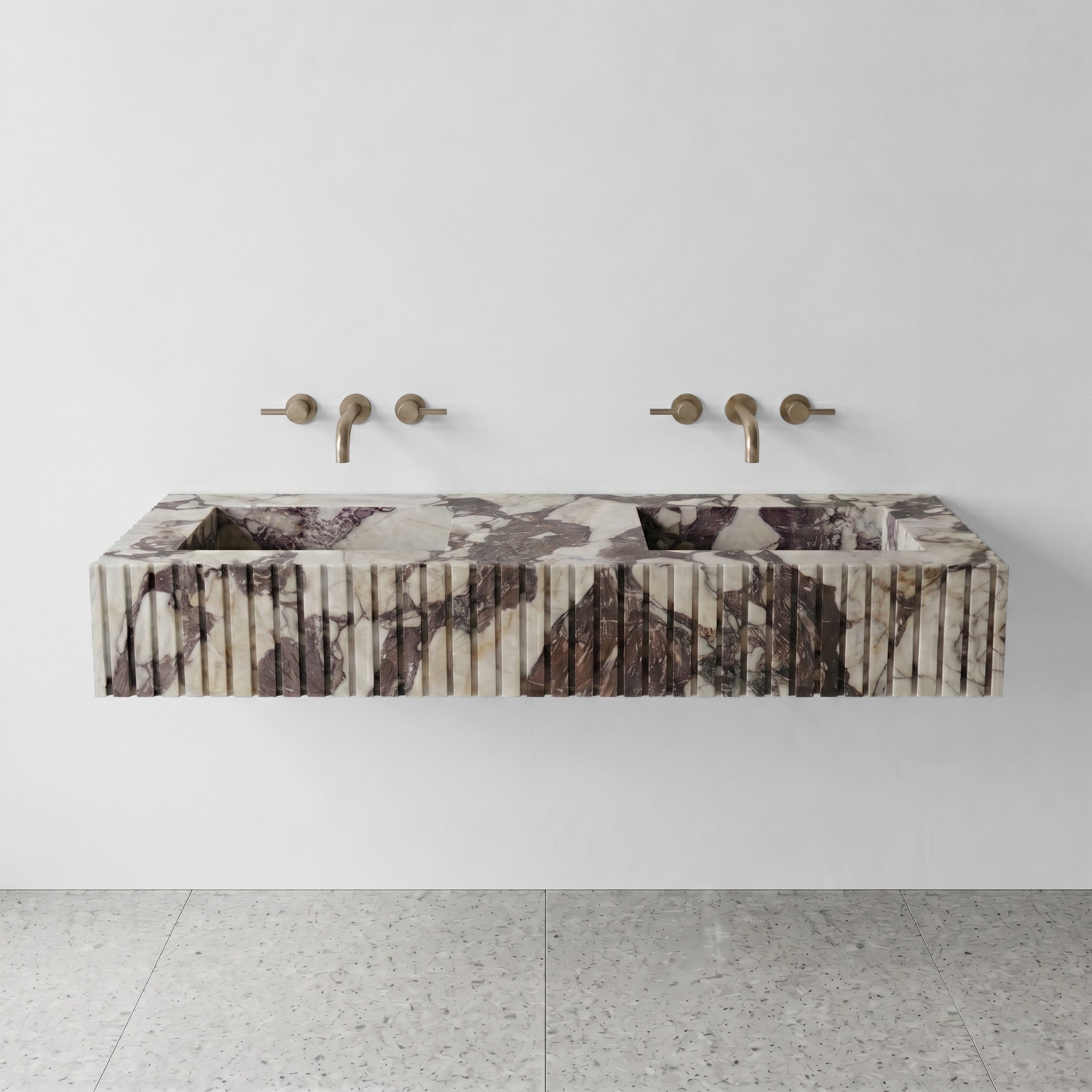 Front profile of a statement Calacatta Viola Extra marble double vanity, featuring a custom fluted stone apron and dramatic burgundy veining.