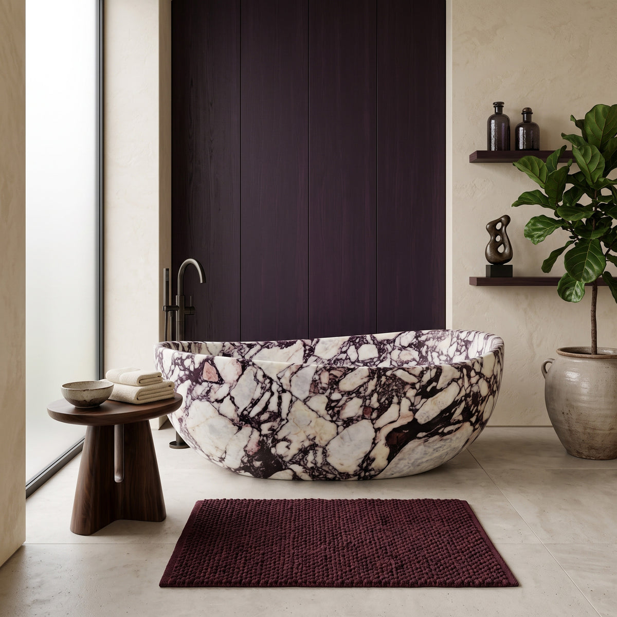 Moody luxury bathroom interior featuring the freestanding Calacatta Viola marble wave bathtub paired with a floor-mounted dark bronze tub filler, a rich aubergine wood accent wall, a sculpted dark timber side table, a deep burgundy bath mat, and open display shelving.