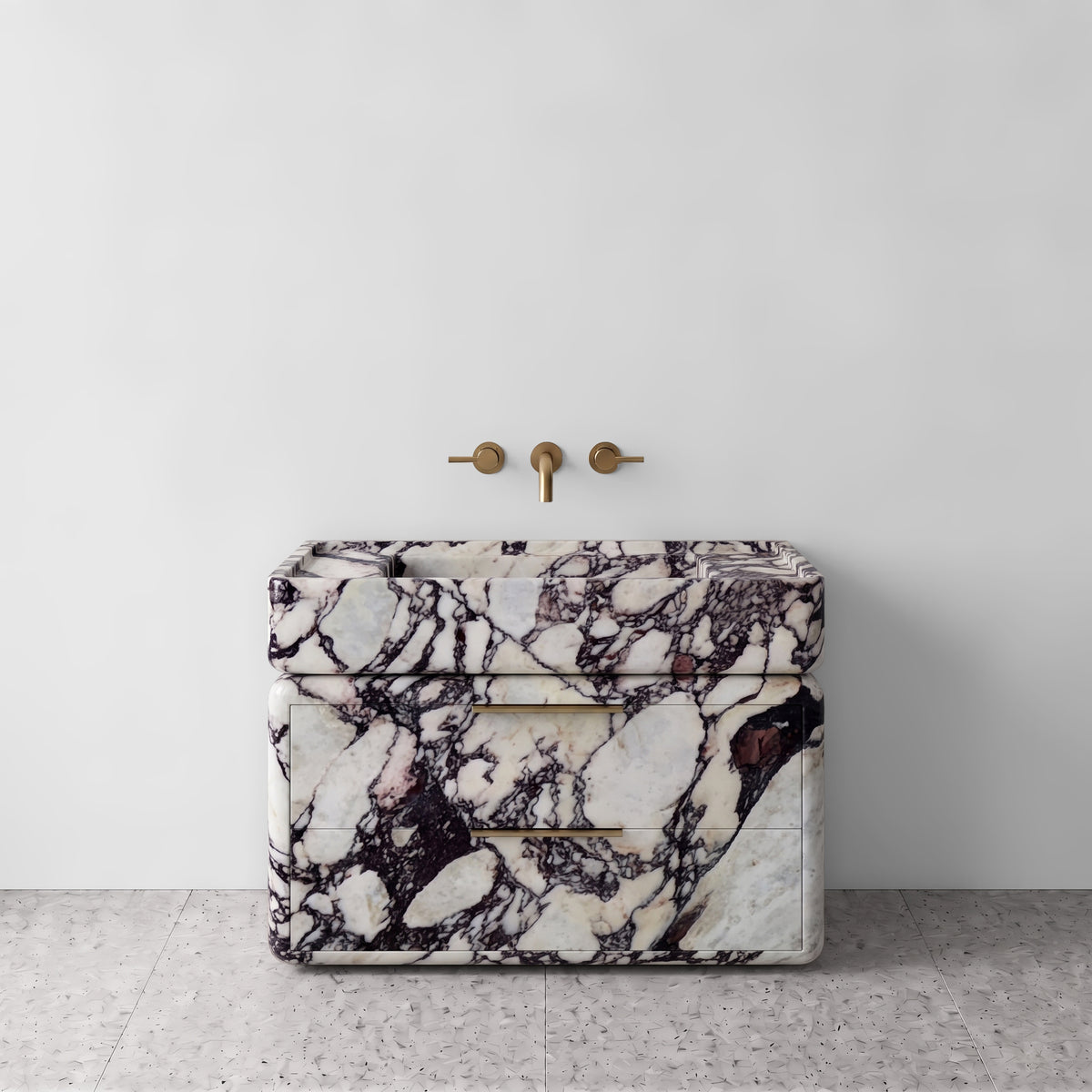 Front studio view of the freestanding Calacatta Viola marble double-drawer vanity, showcasing curved edges, dramatic burgundy and wine-red breccia veining on white marble, an integrated trough basin, and horizontal brushed brass pulls paired with wall-mounted brass tapware against a clean backdrop.