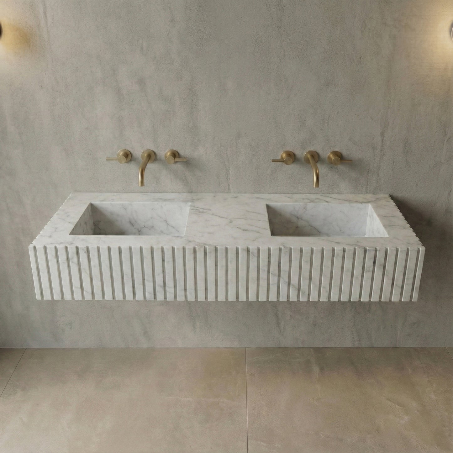 Front profile of a floating double vanity made from honed Carrara marble, featuring a custom ribbed stone apron and dual integrated basins.