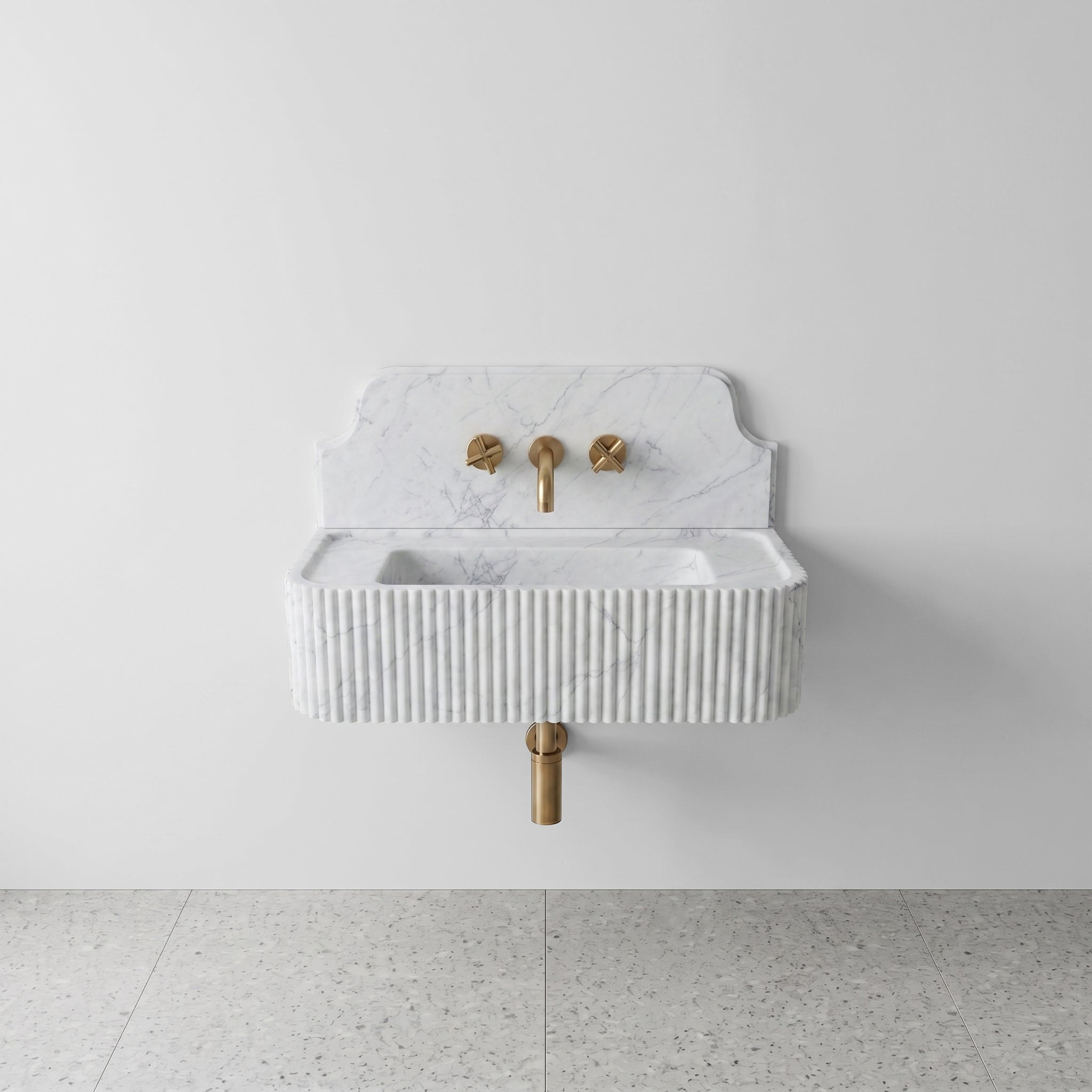 Front profile of a wall-mounted Carrara marble washbasin featuring a decorative high backsplash, vertical ribbed texture, and soft grey natural veining.