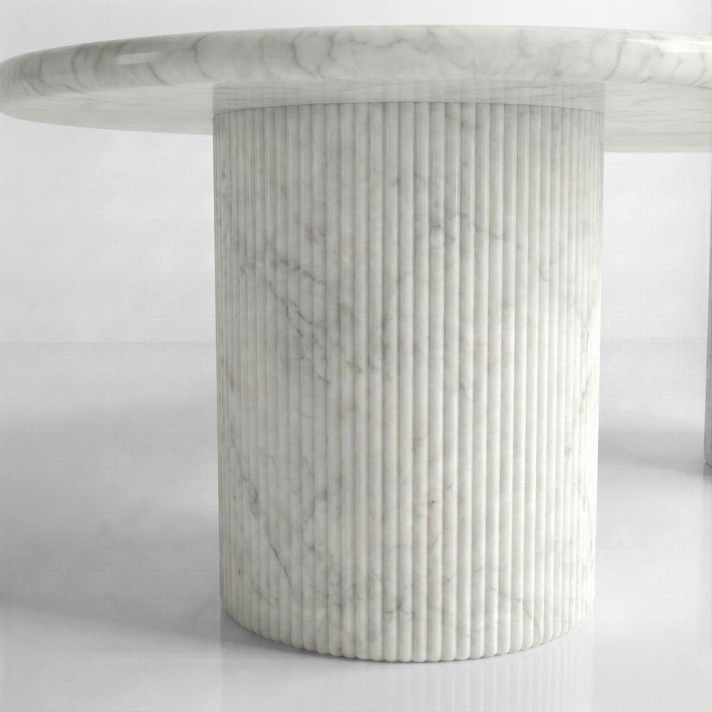 Detail shot of a fluted column table base crafted from Carrara marble, showcasing the vertical ribbed texture and classic Italian stone craftsmanship.