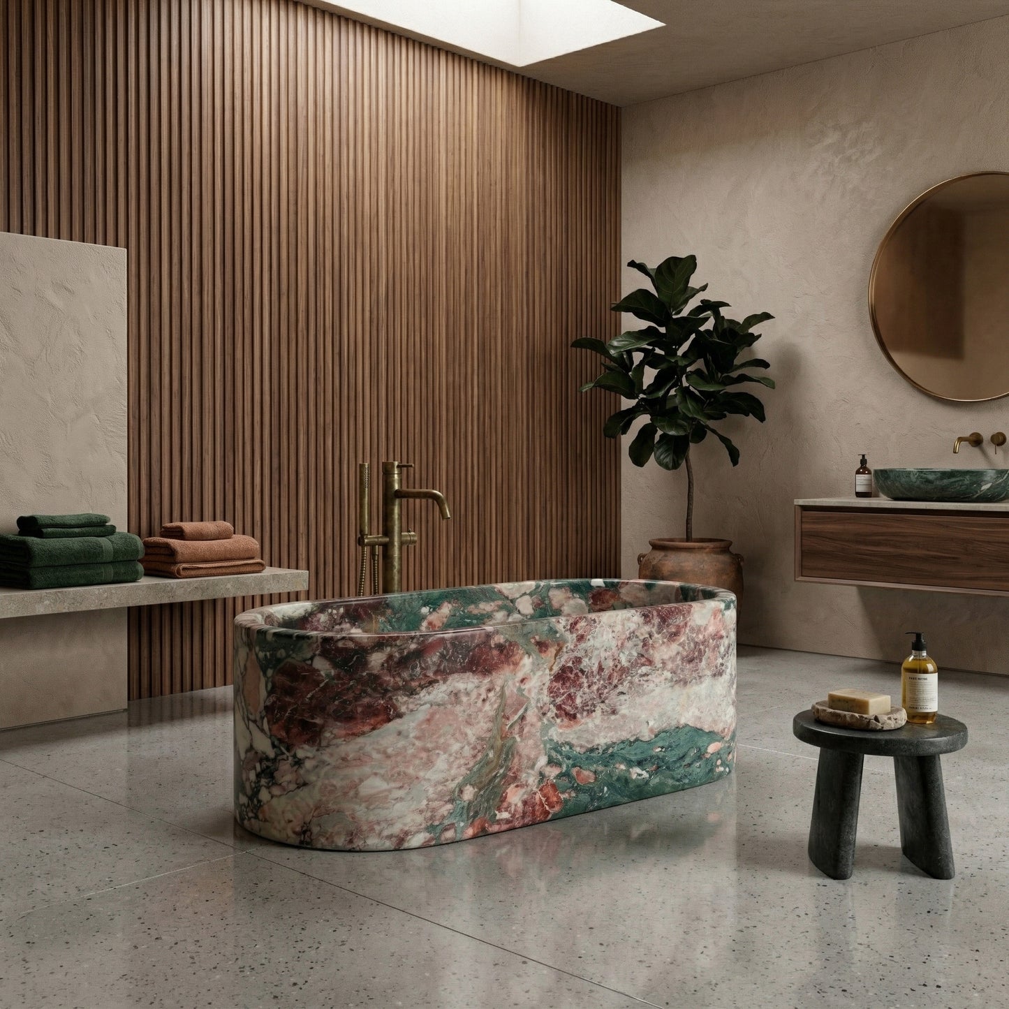 Opulent luxury bathroom centered around a colorful Four Seasons marble bathtub, with matching green marble flooring, fluted wall accents, and brushed gold fixtures.