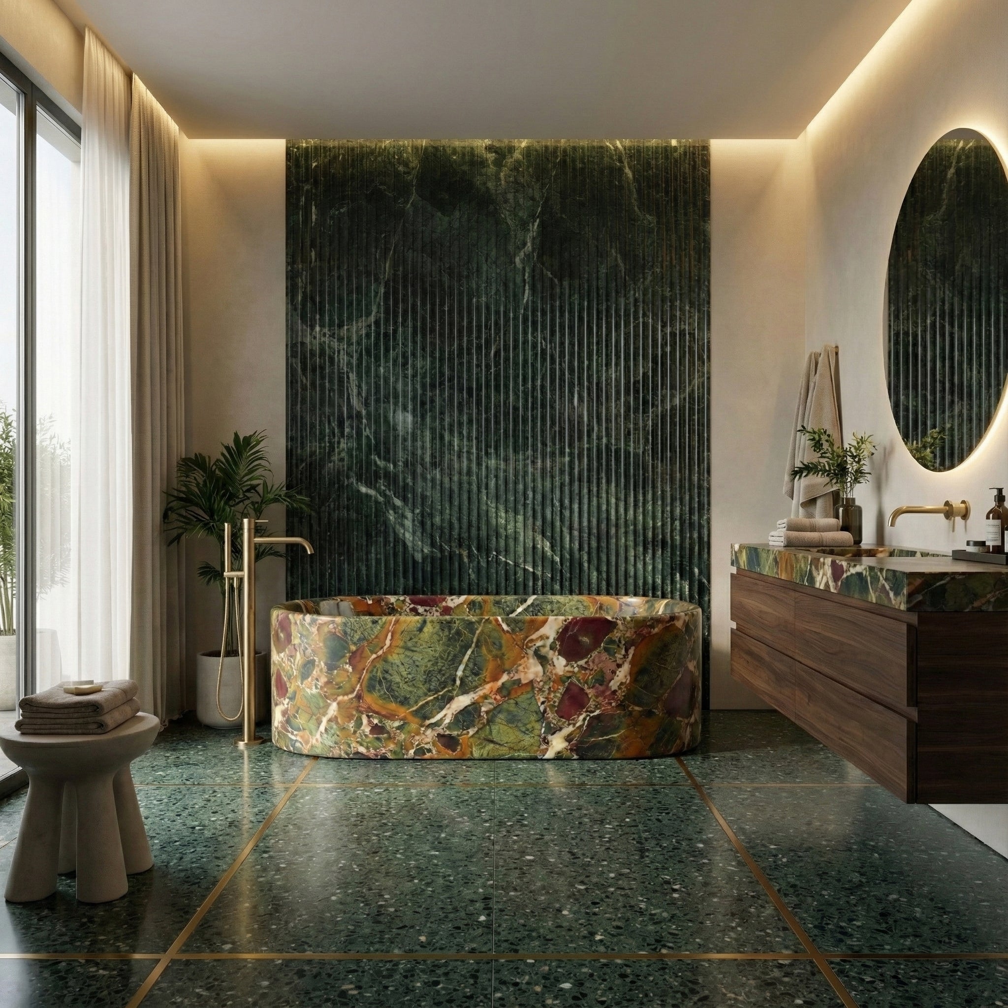 Opulent luxury bathroom centered around a colorful Four Seasons marble bathtub, with matching green marble flooring, fluted wall accents, and brushed gold fixtures.
