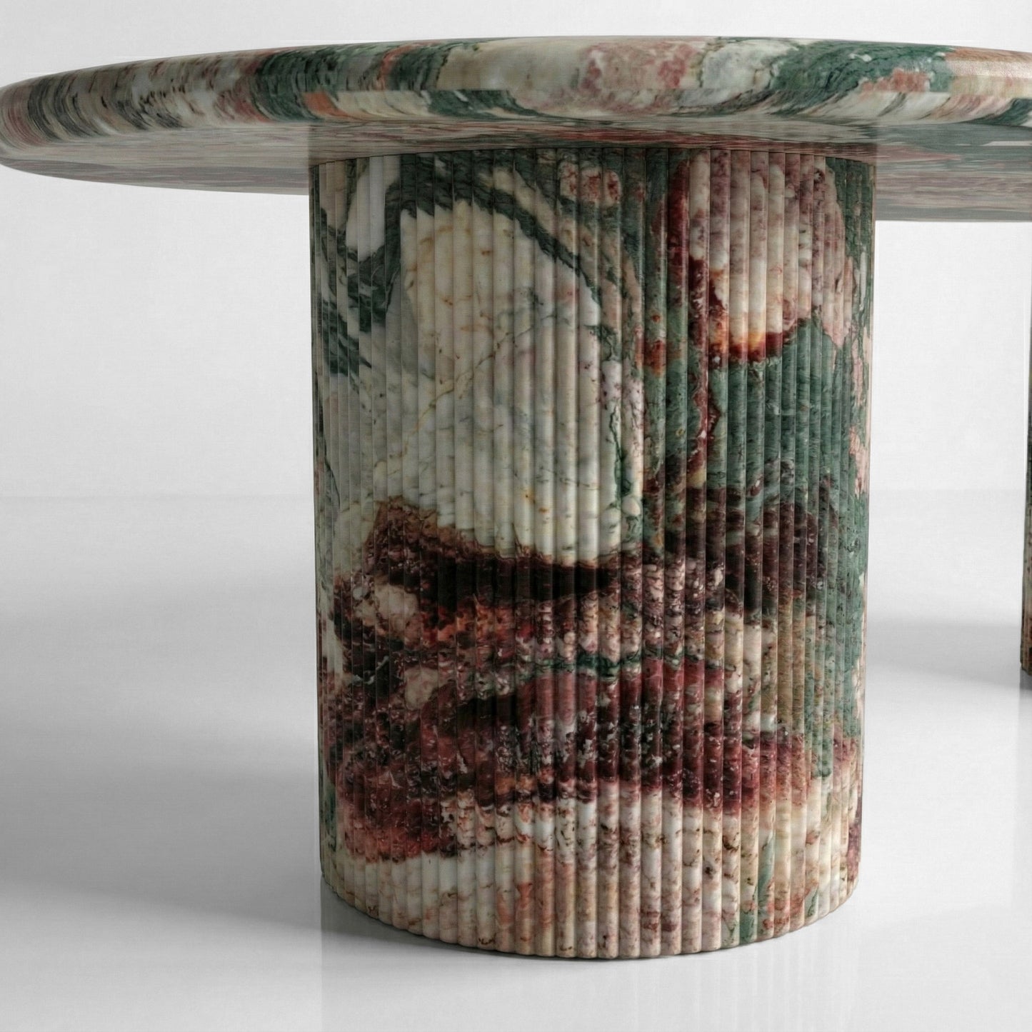 Close-up detail of a fluted column table base crafted from Four Seasons marble, featuring a kaleidoscope of forest green, purple, and rust-colored mineral patterns.