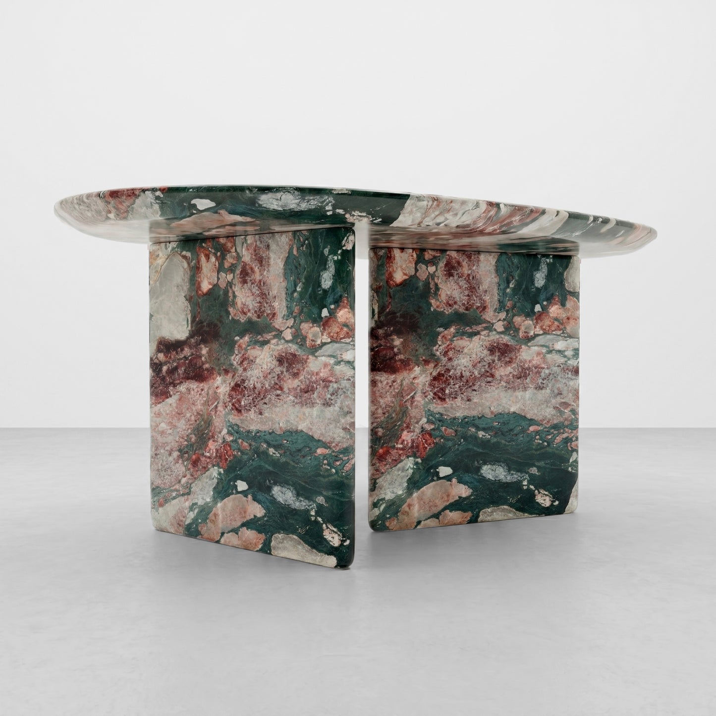 Close-up detail of the polished edge and intricate crystalline patterns of Four Seasons marble, displaying rich green, pink, and burgundy natural stone textures.